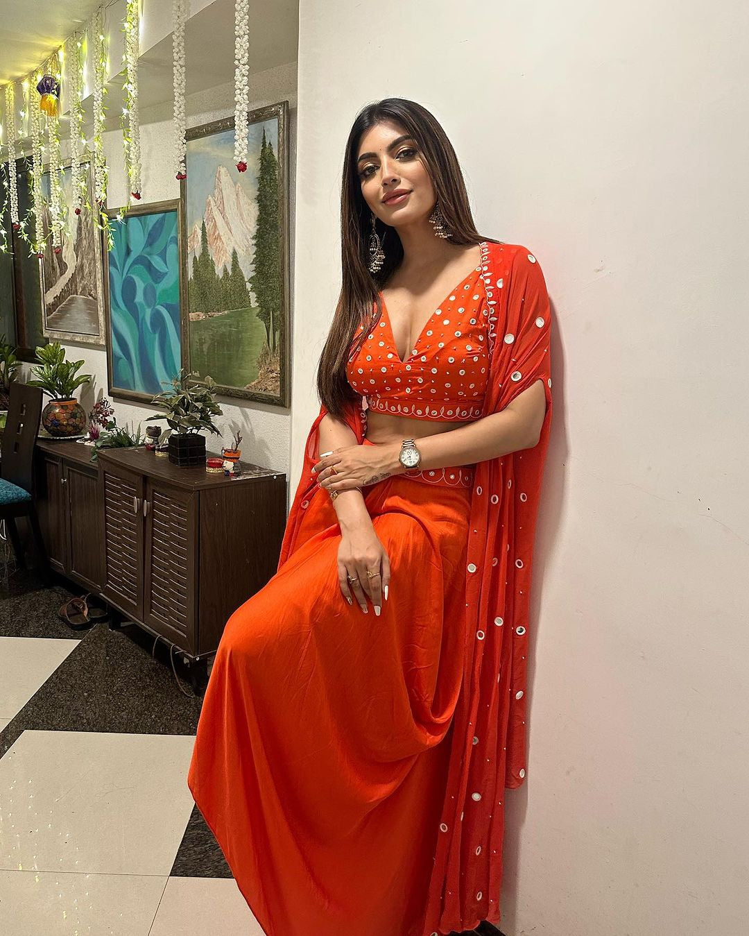 Tangerine orange dhoti set with a mirror-work blouse, dhoti, and georgette cape, worn by Akansha Puri.