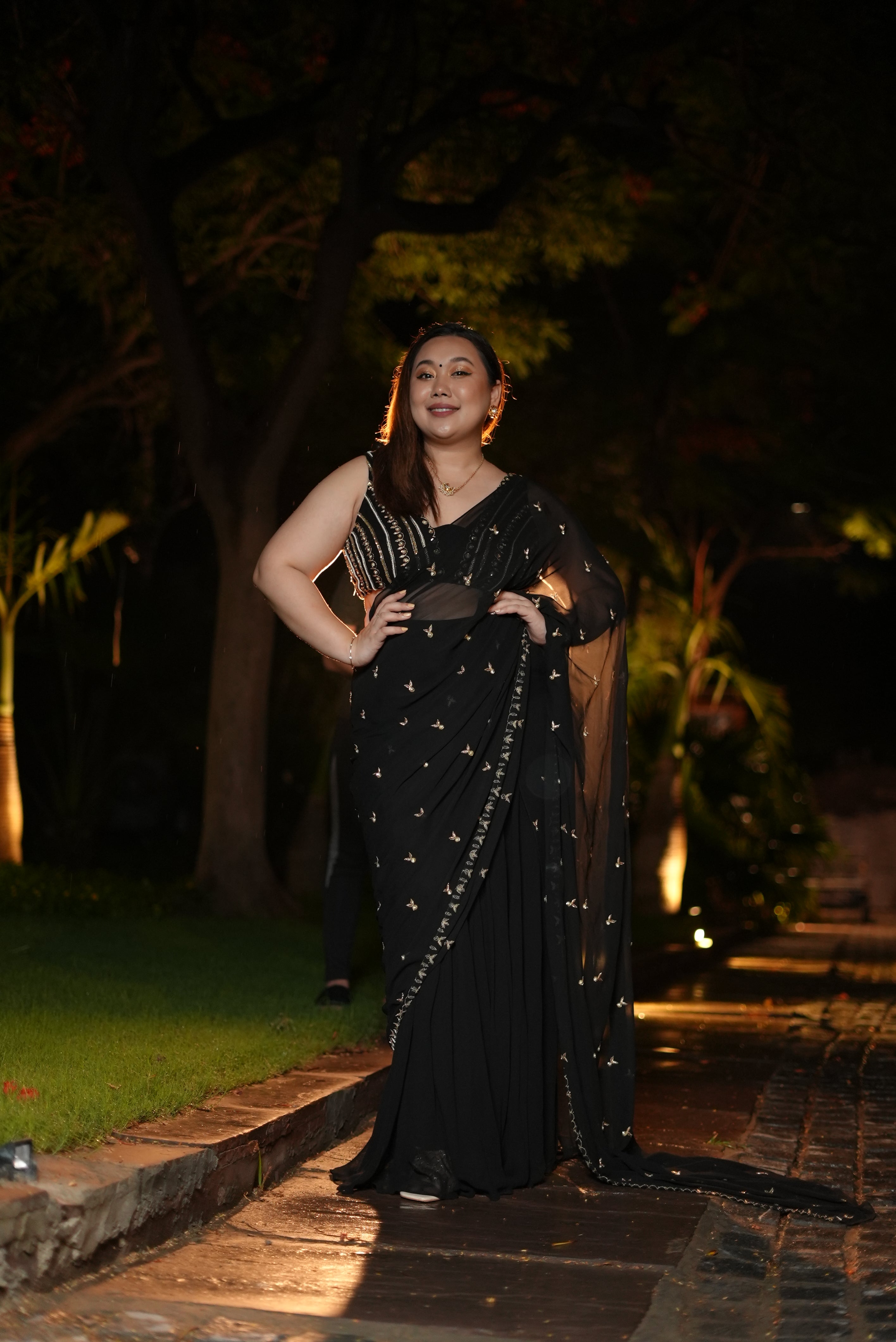 Shraddha Gurung in a black hand-embroidered saree set with intricate detailing.