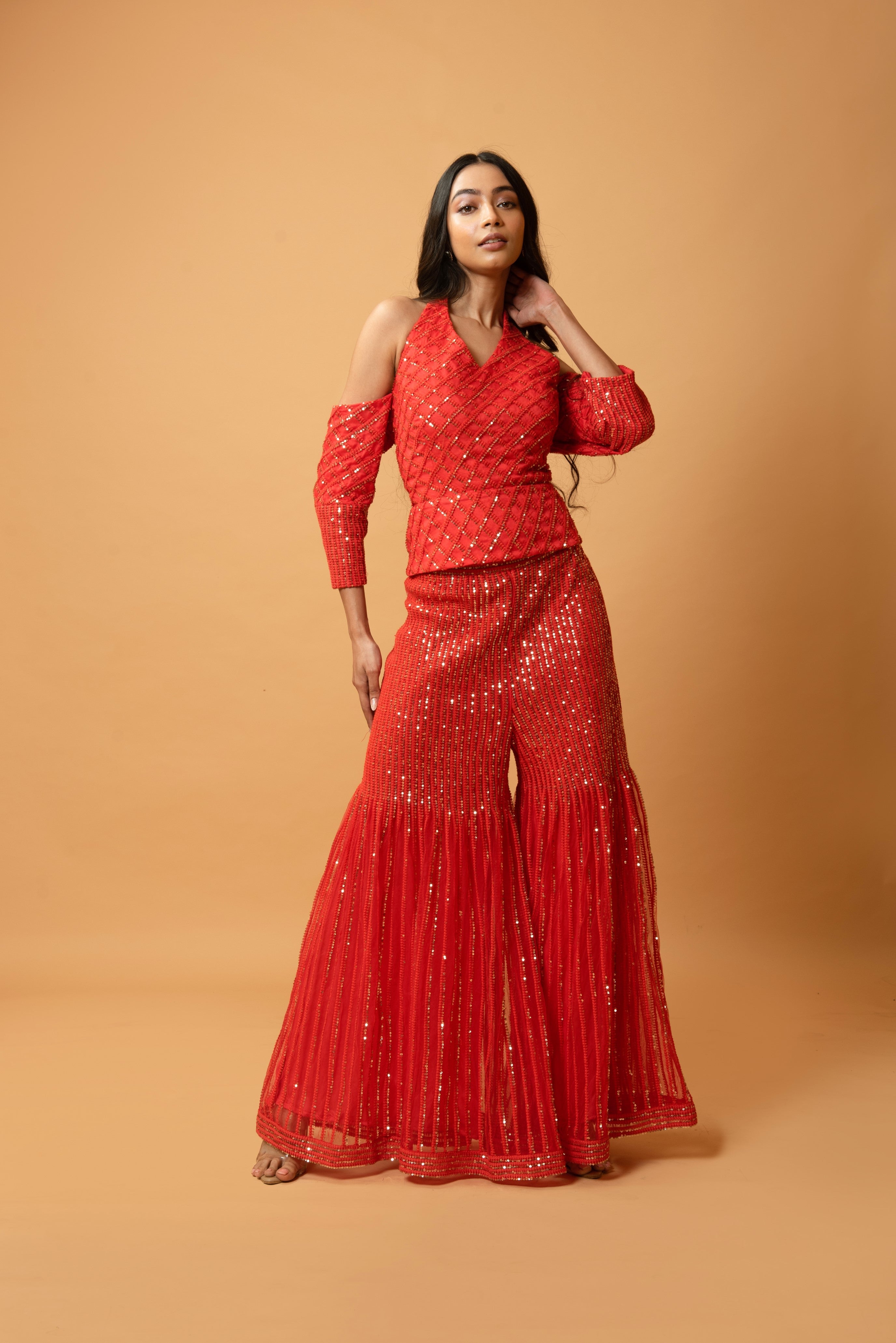 Red sequined tulle sharara set with a halterneck off-shoulder top.