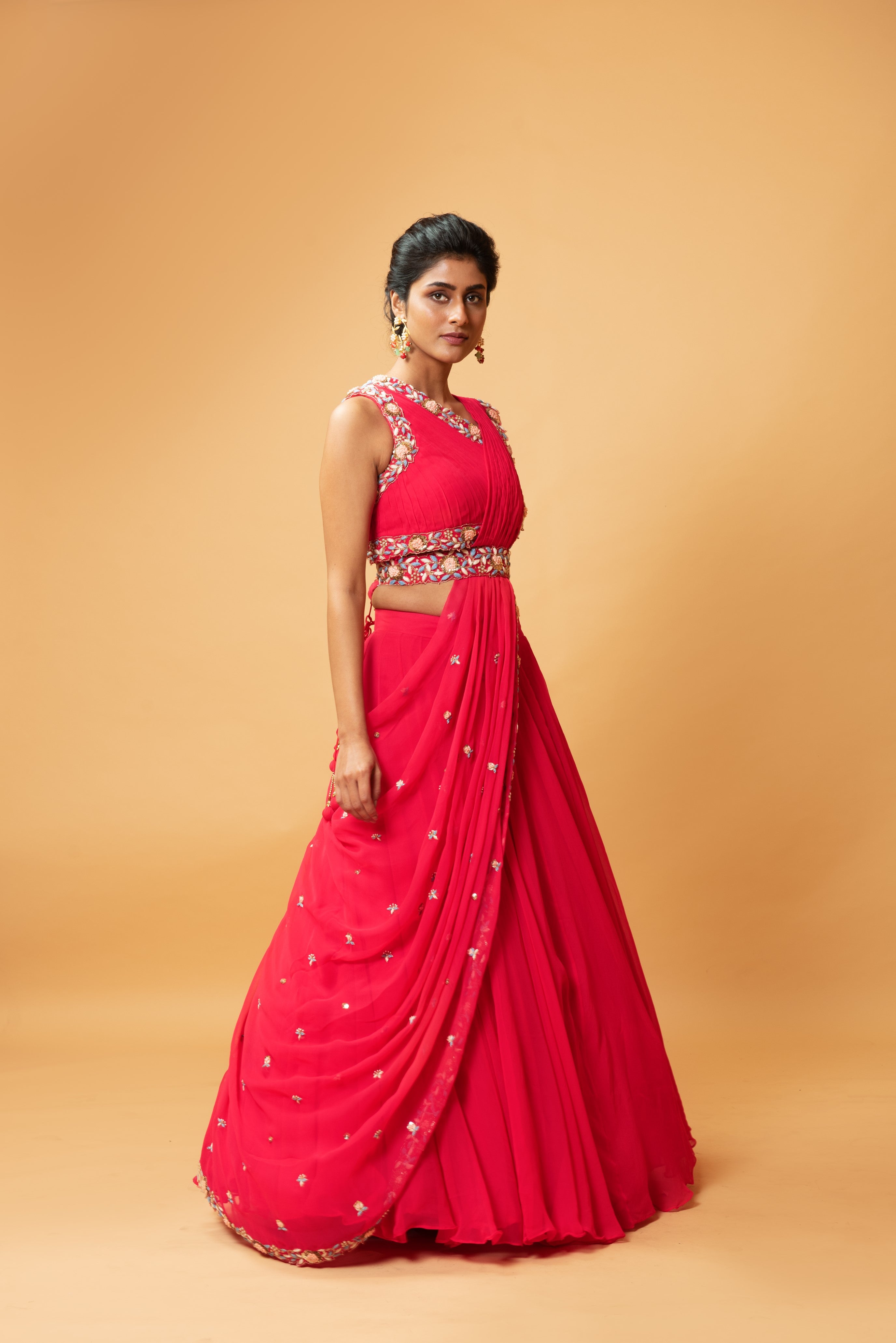Fuschia pink draped lehenga with hand-embroidered waist belt.
