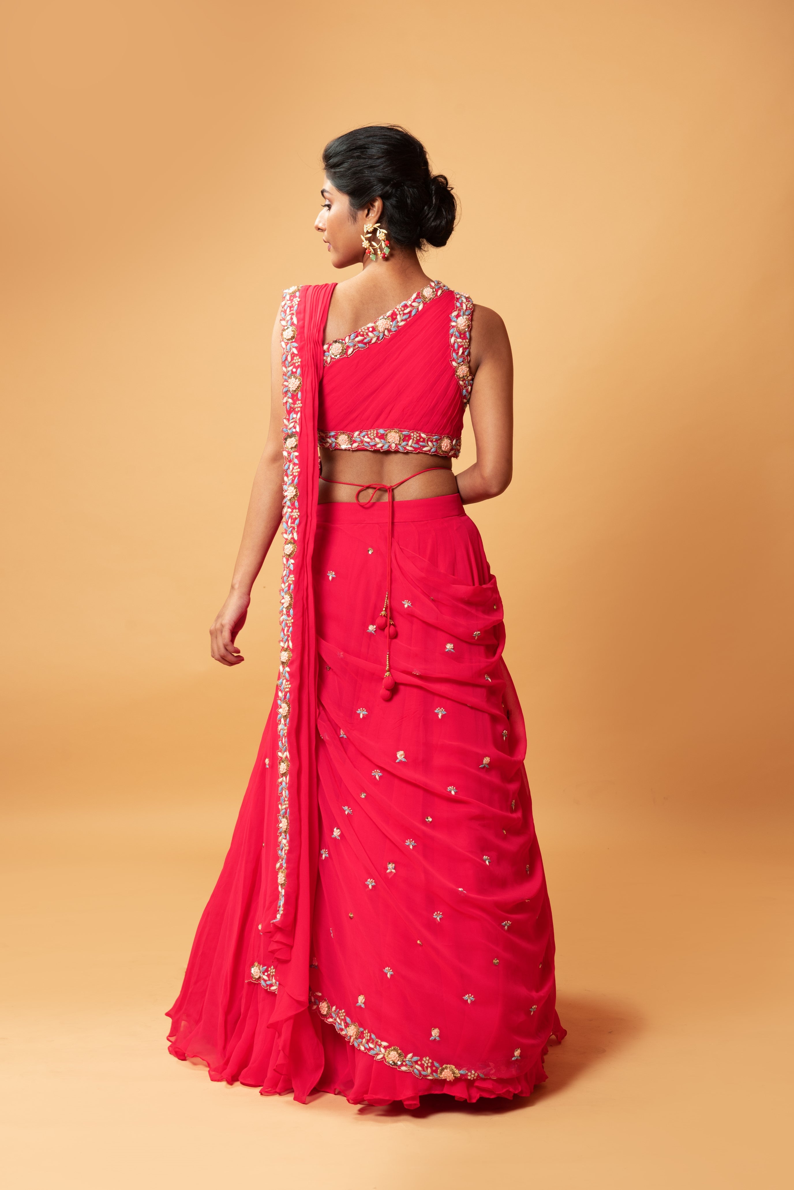 Fuschia pink draped lehenga with hand-embroidered waist belt.