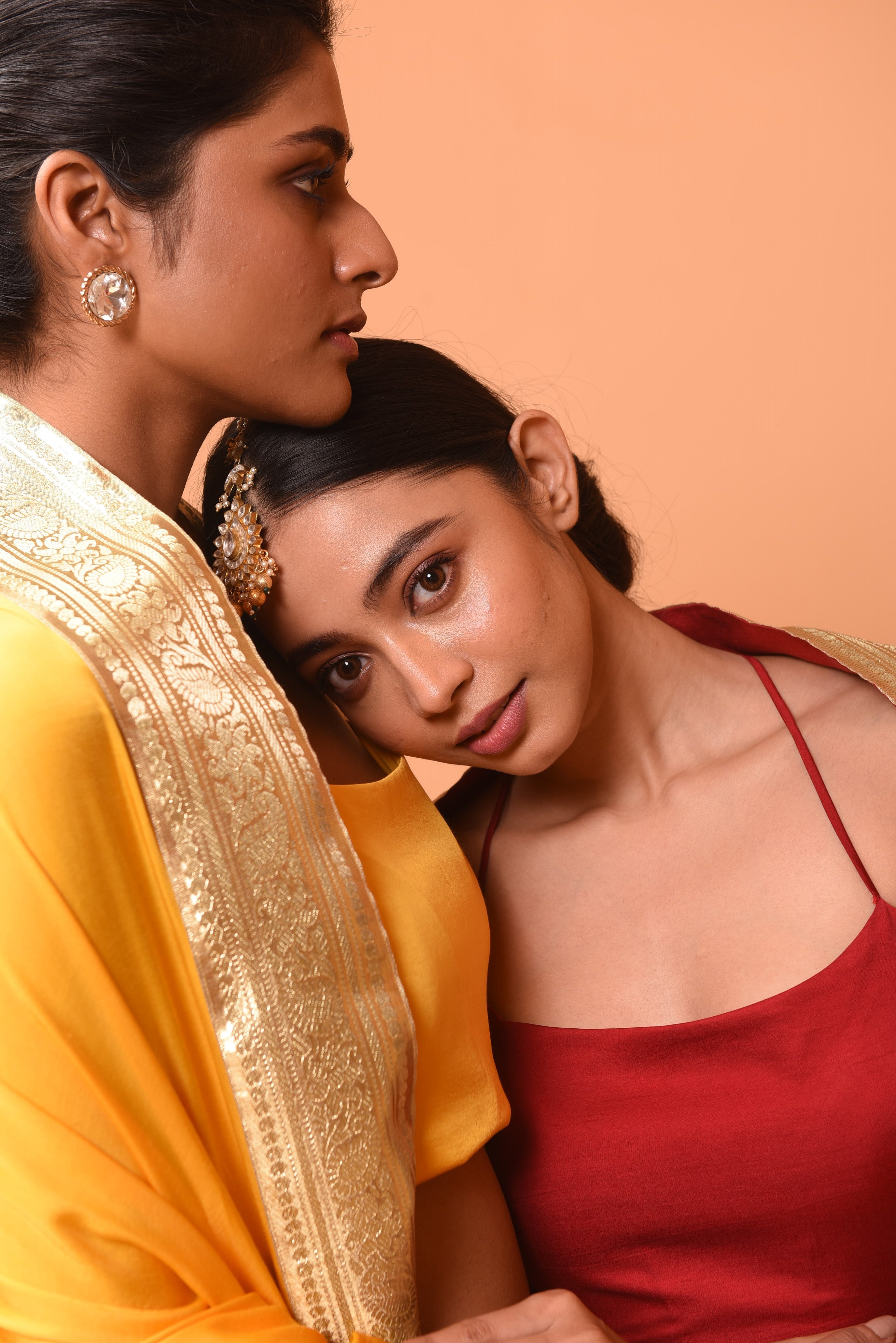 Bright yellow sleeveless lehenga with golden zari-bordered dupatta.