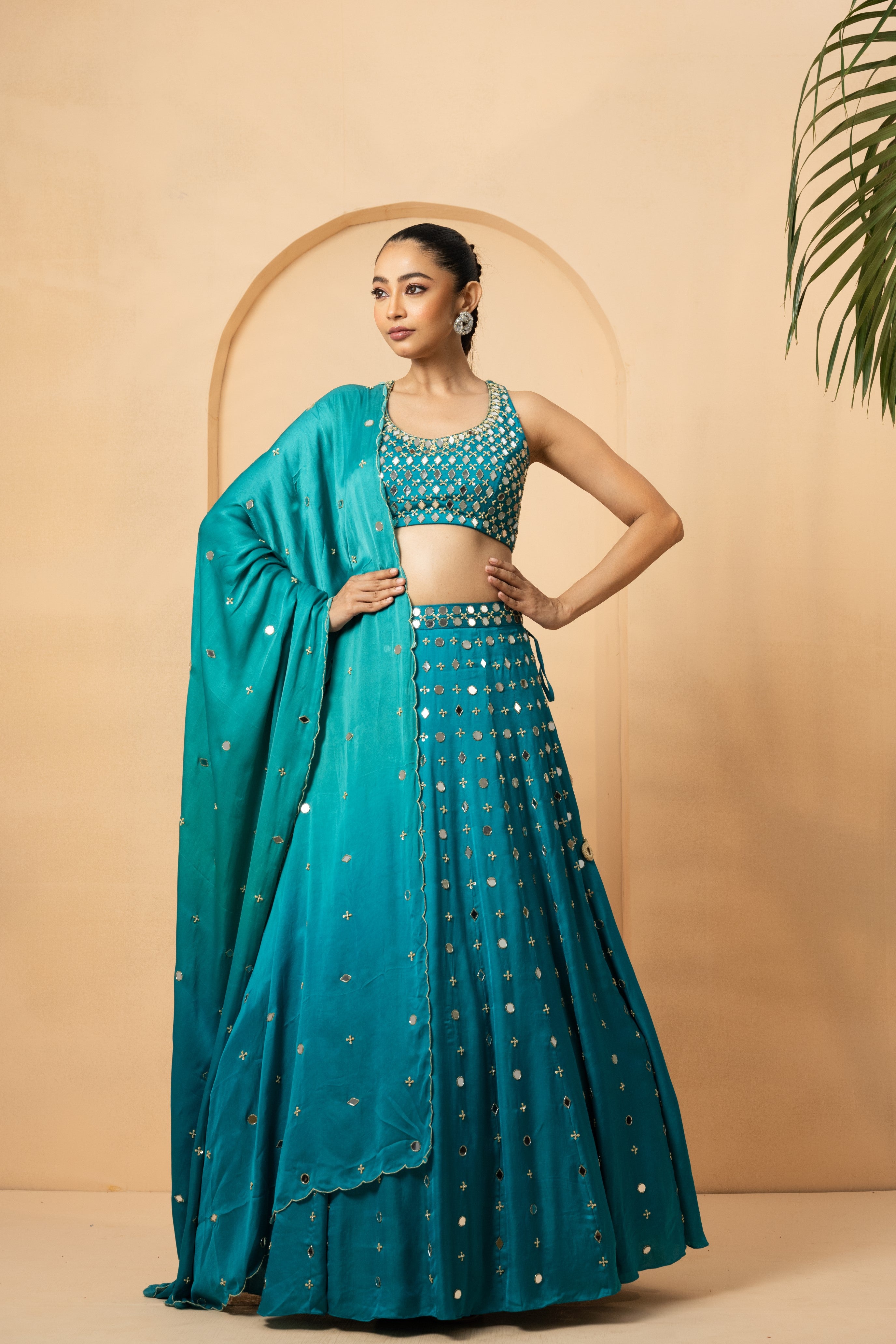 Turquoise mirror lehenga set with pearl beadwork and matching dupatta.