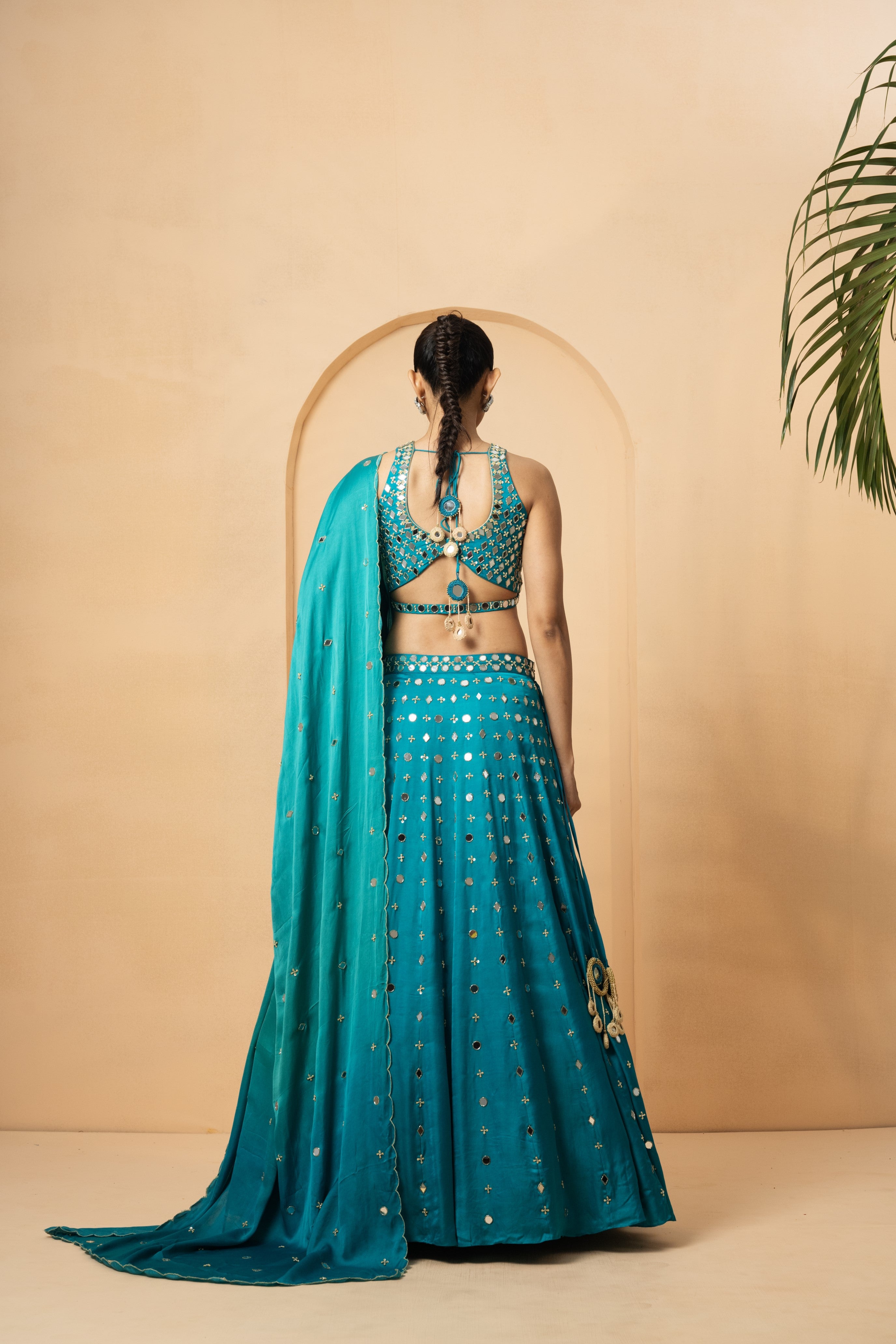 Turquoise mirror lehenga set with pearl beadwork and matching dupatta.