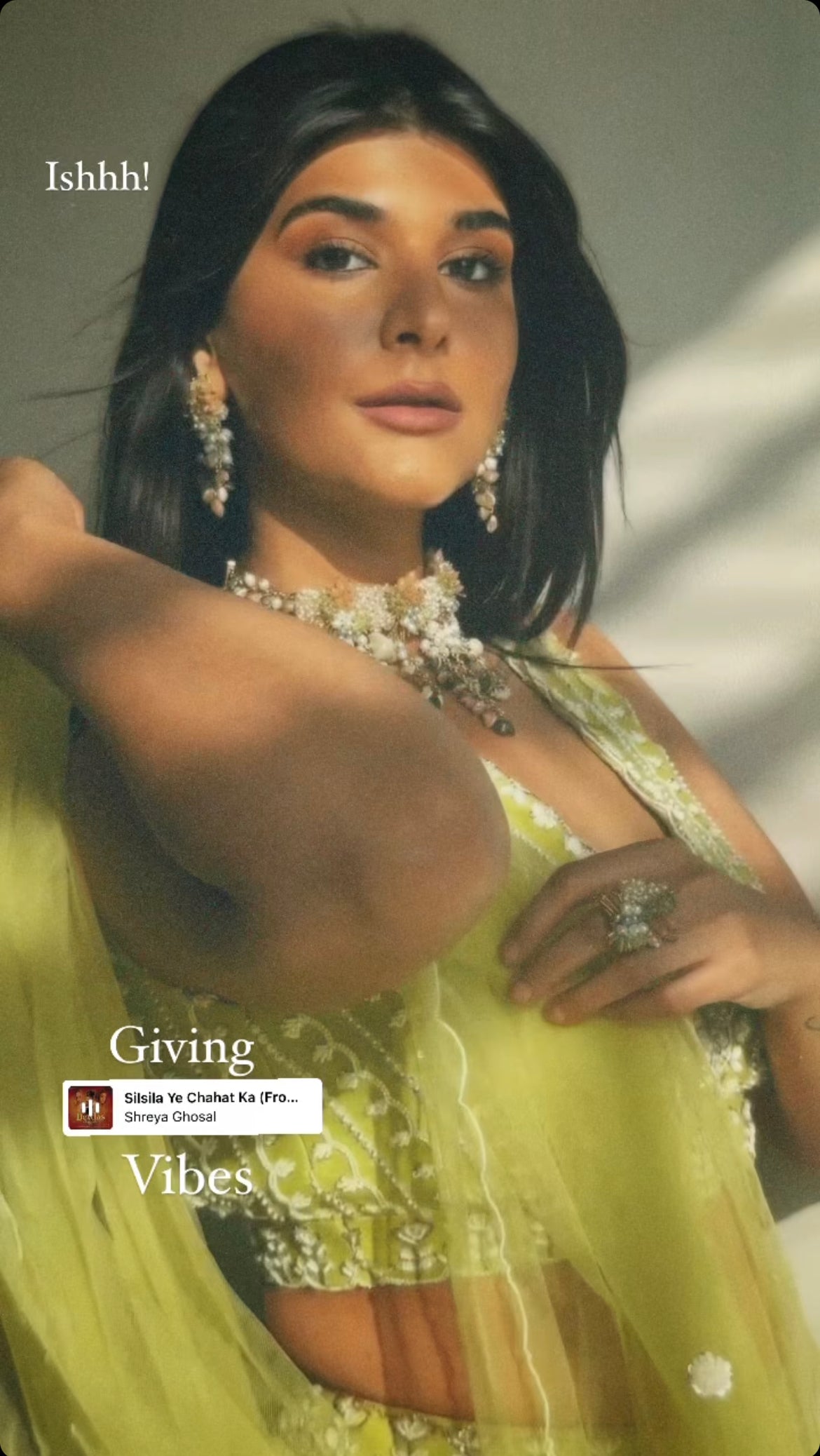 Lime green lehenga with embroidered blouse, belt, and choker dupatta.