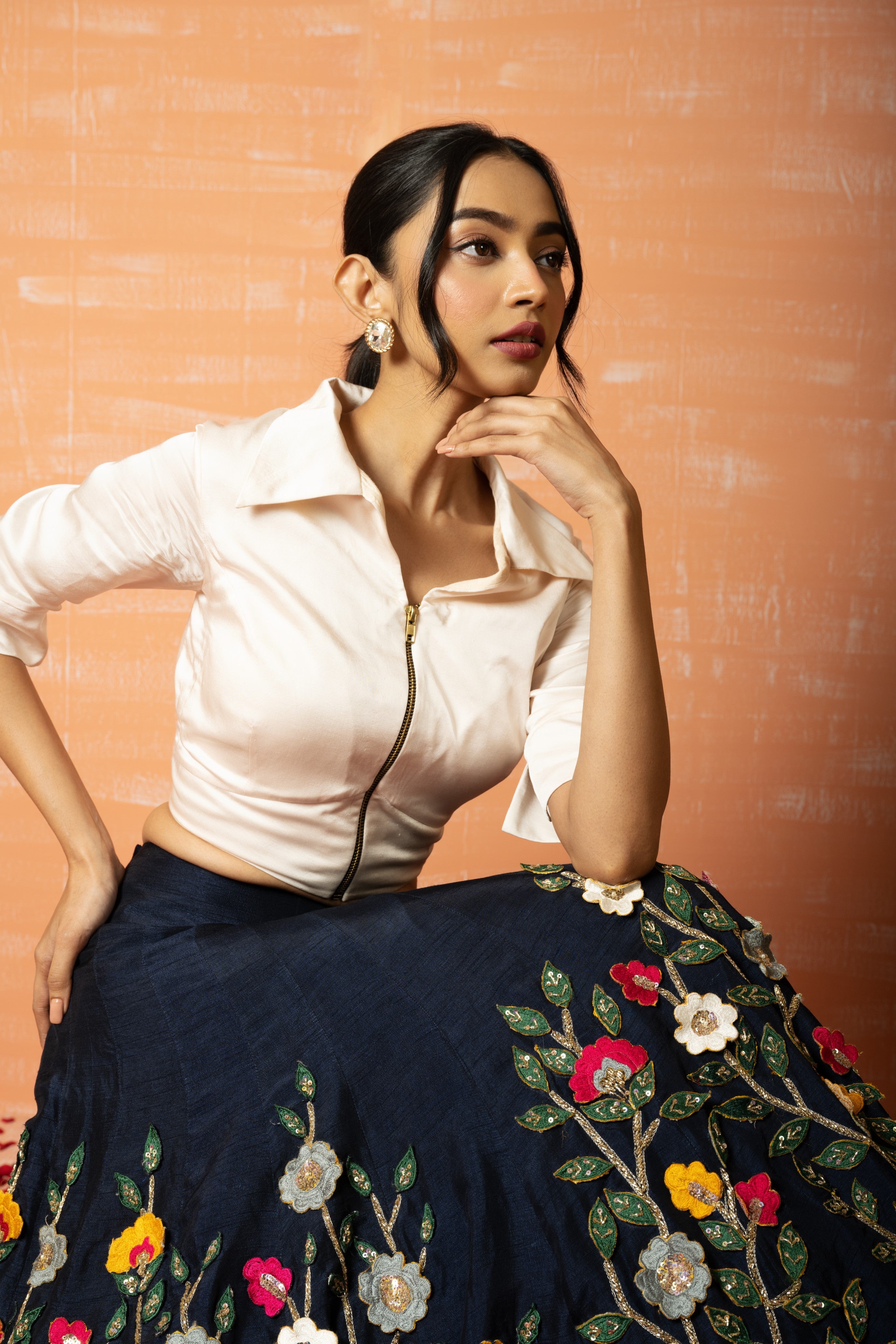 White shirt and blue 3D half lehenga set with intricate applique embroidery.