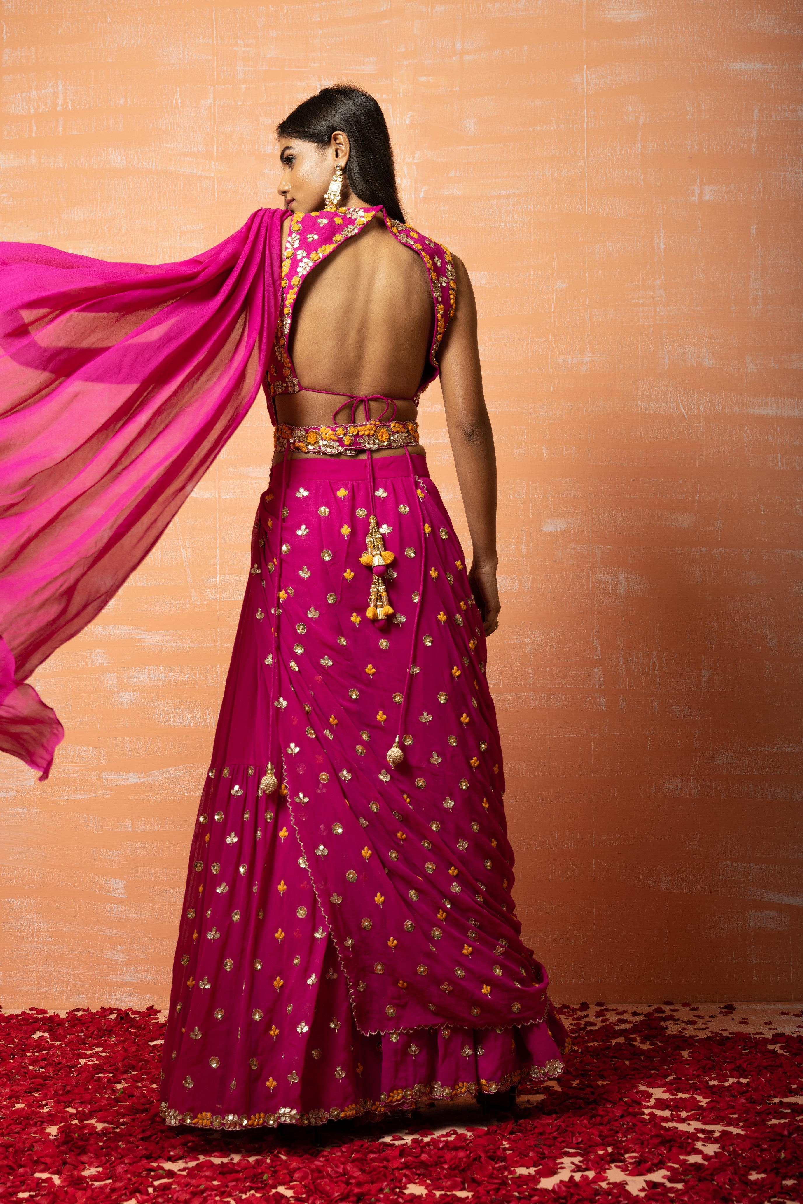 Purple pre-stitched sharara saree set with intricate embroidery and a matching belt.