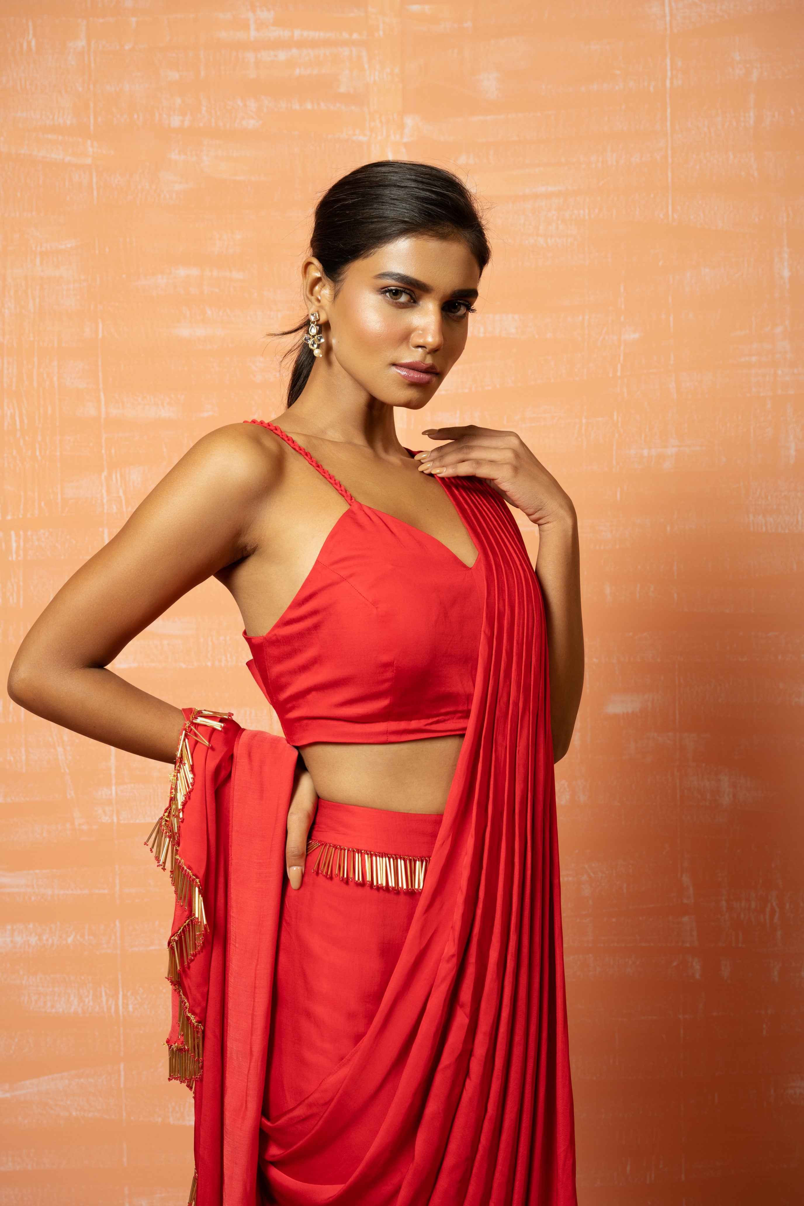 Red pre-stitched saree in modal silk with lace embellishments.
