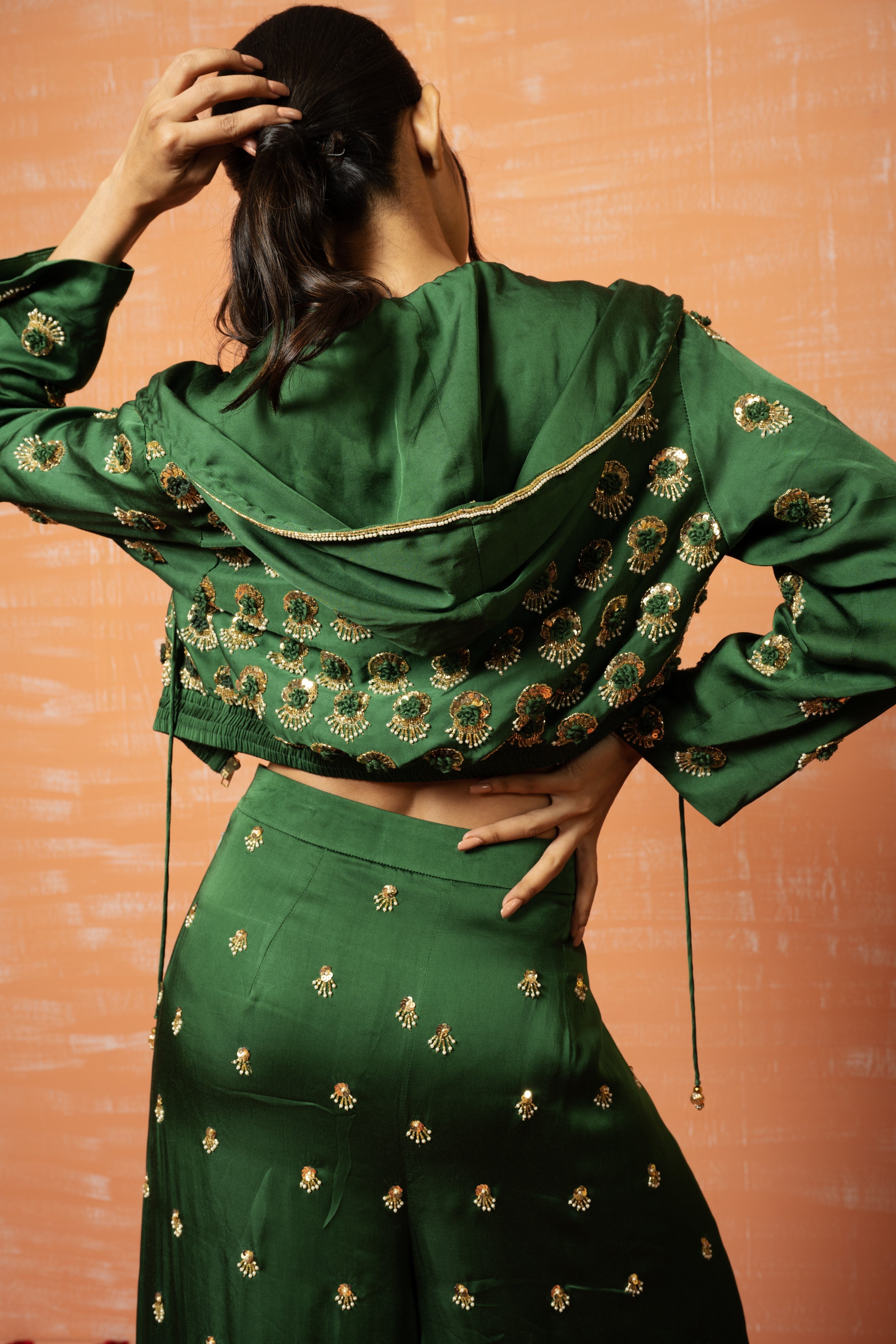 Mehendi green hoodie and palazzo set with hand embroidery.