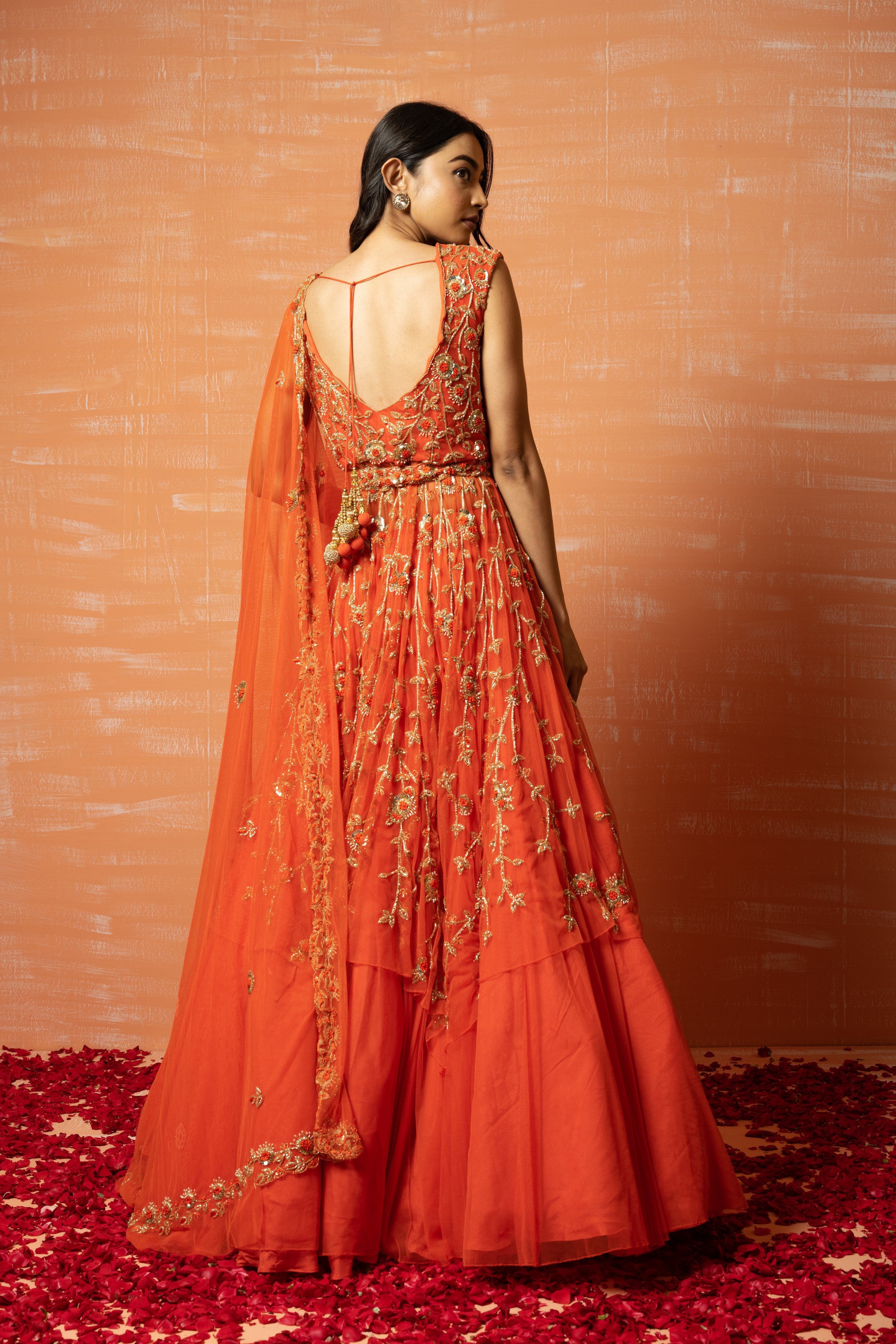 Orange soft net lehenga set with intricate zardosi embroidery, dupatta, and waist belt.