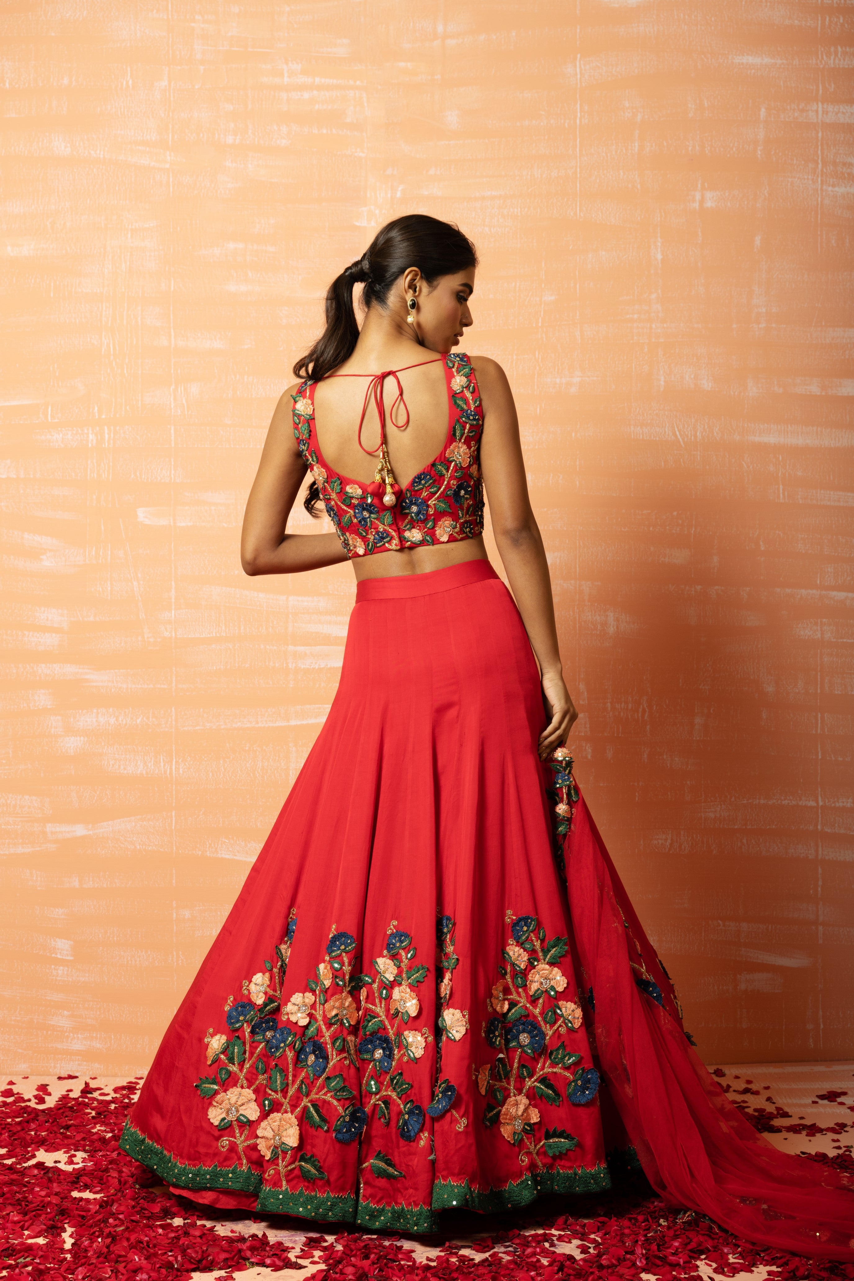 Red modal silk lehenga with 3D applique embroidery and a soft net dupatta.