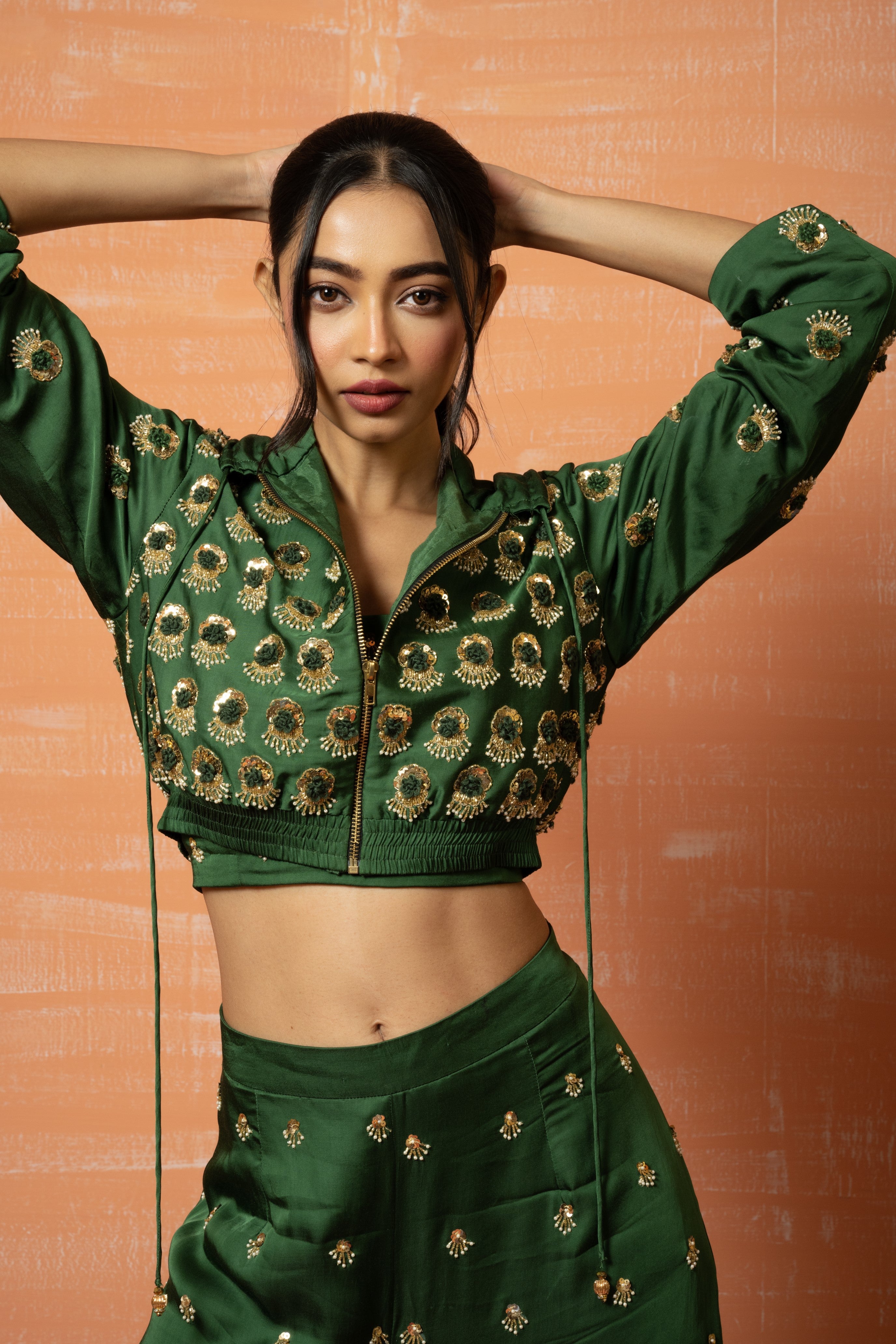 Mehendi green hoodie and palazzo set with hand embroidery.