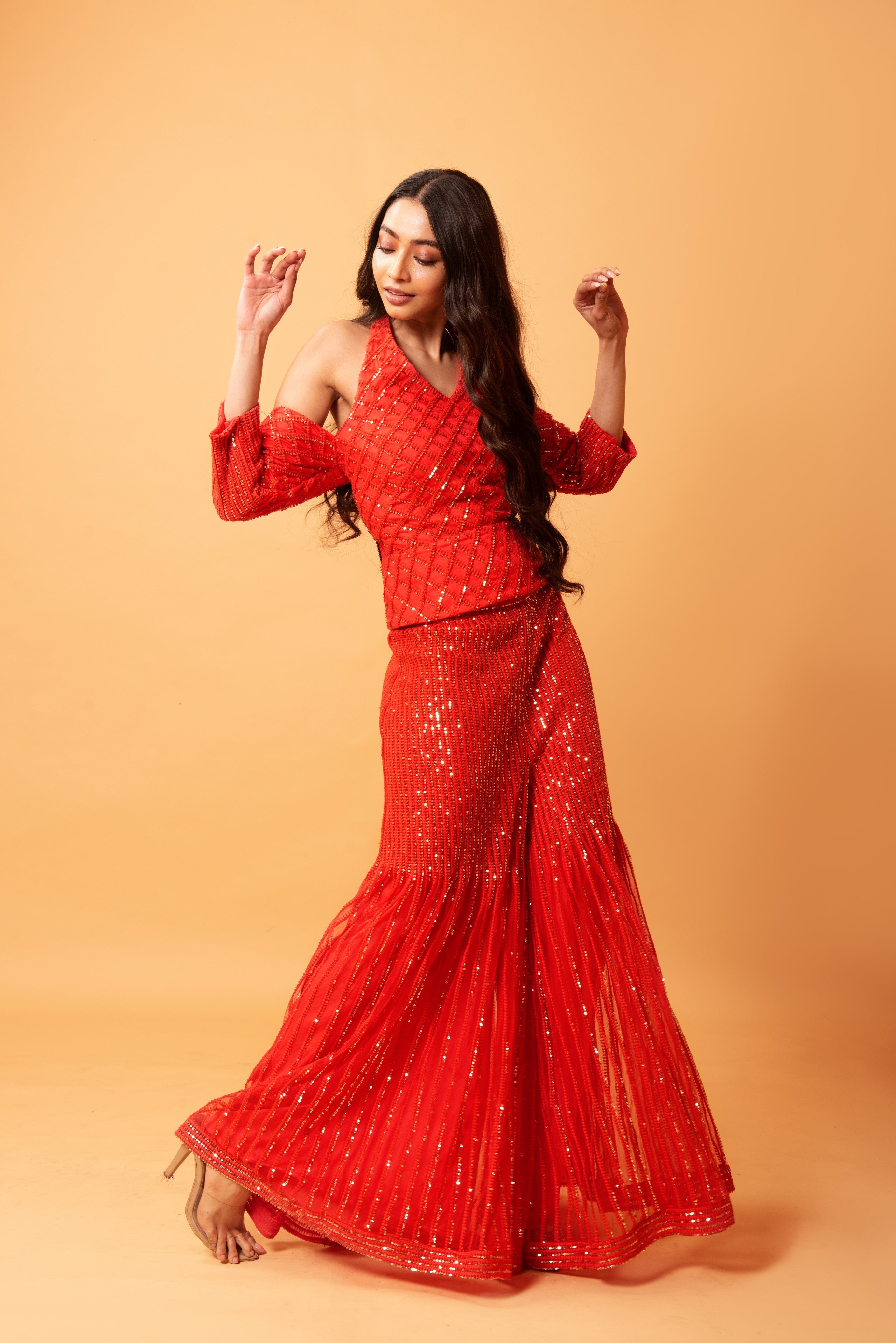 Red sequined tulle sharara set with a halterneck off-shoulder top.