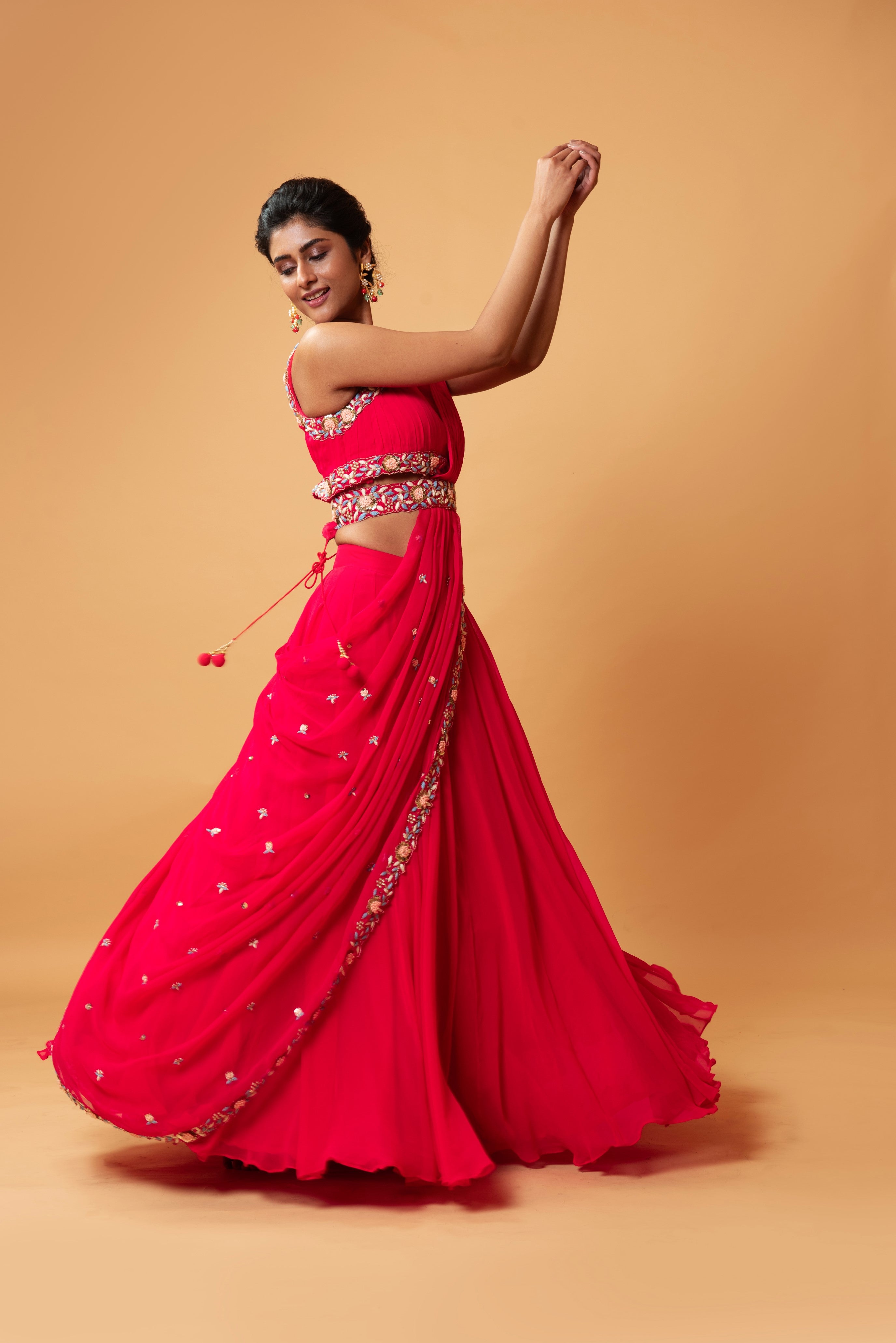 Fuschia pink draped lehenga with hand-embroidered waist belt.