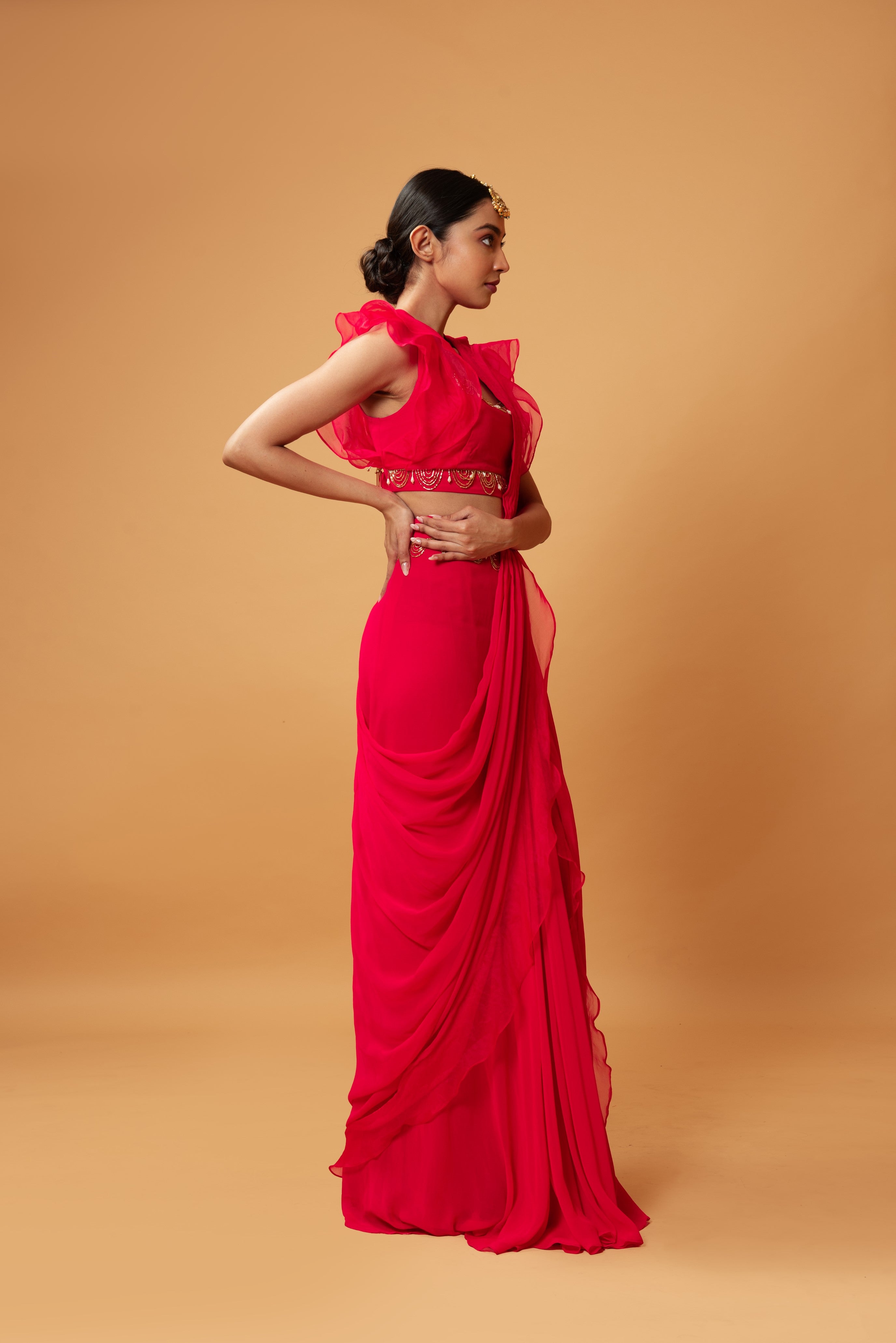 Fuschia pink ruffle saree with lace detailing on neckline and waist.