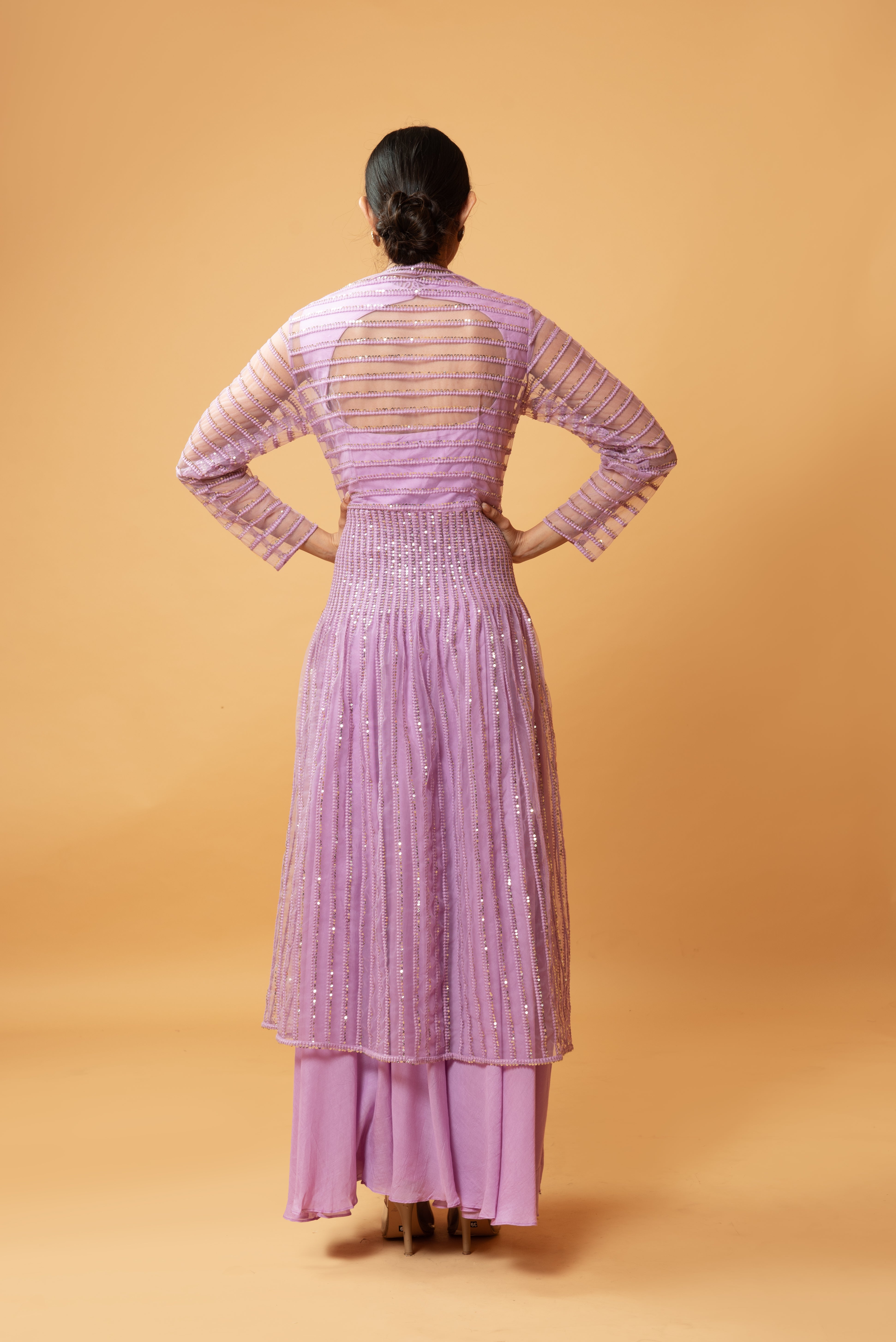 Lilac muslin gown with a sequined full-sleeved jacket.