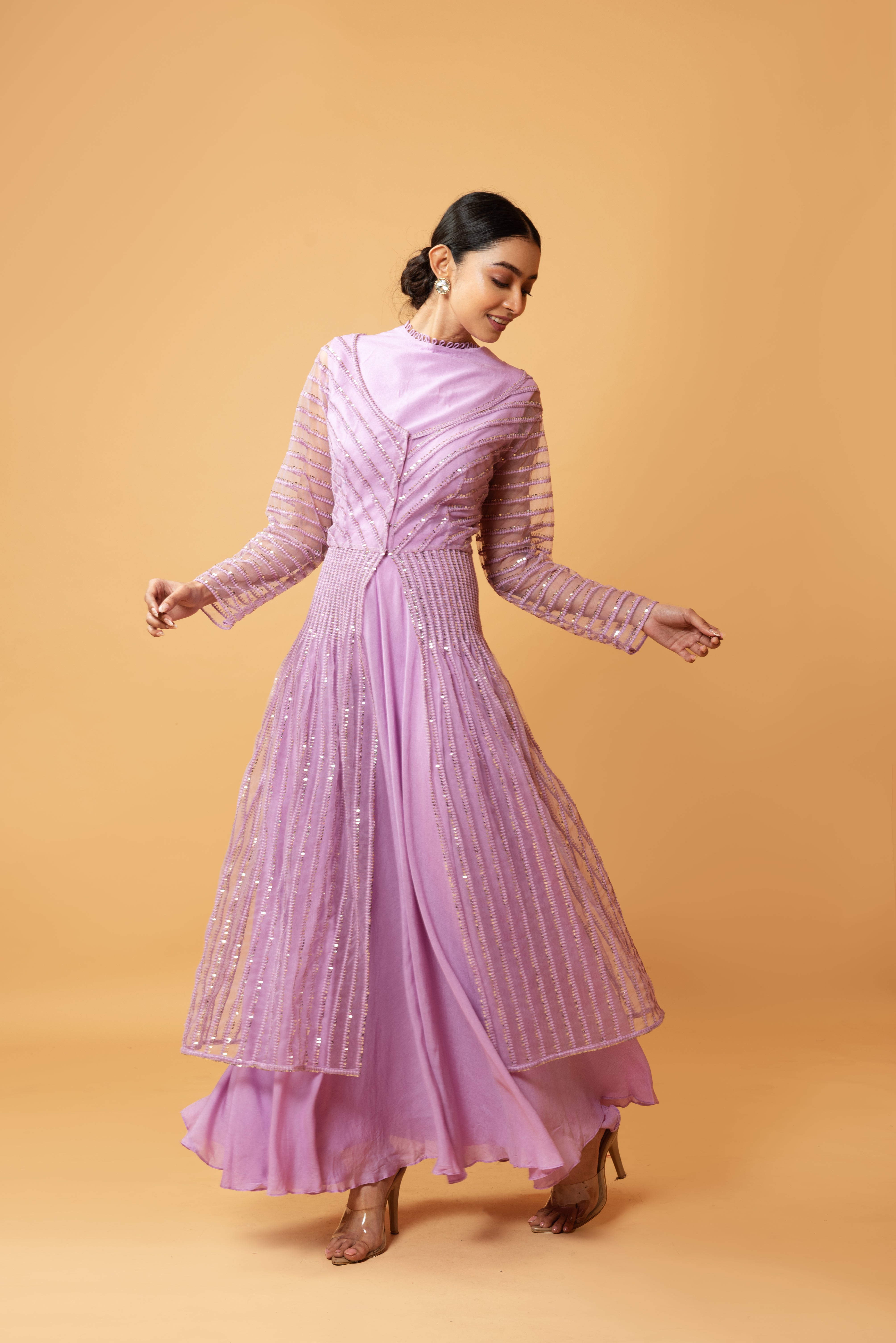 Lilac muslin gown with a sequined full-sleeved jacket.