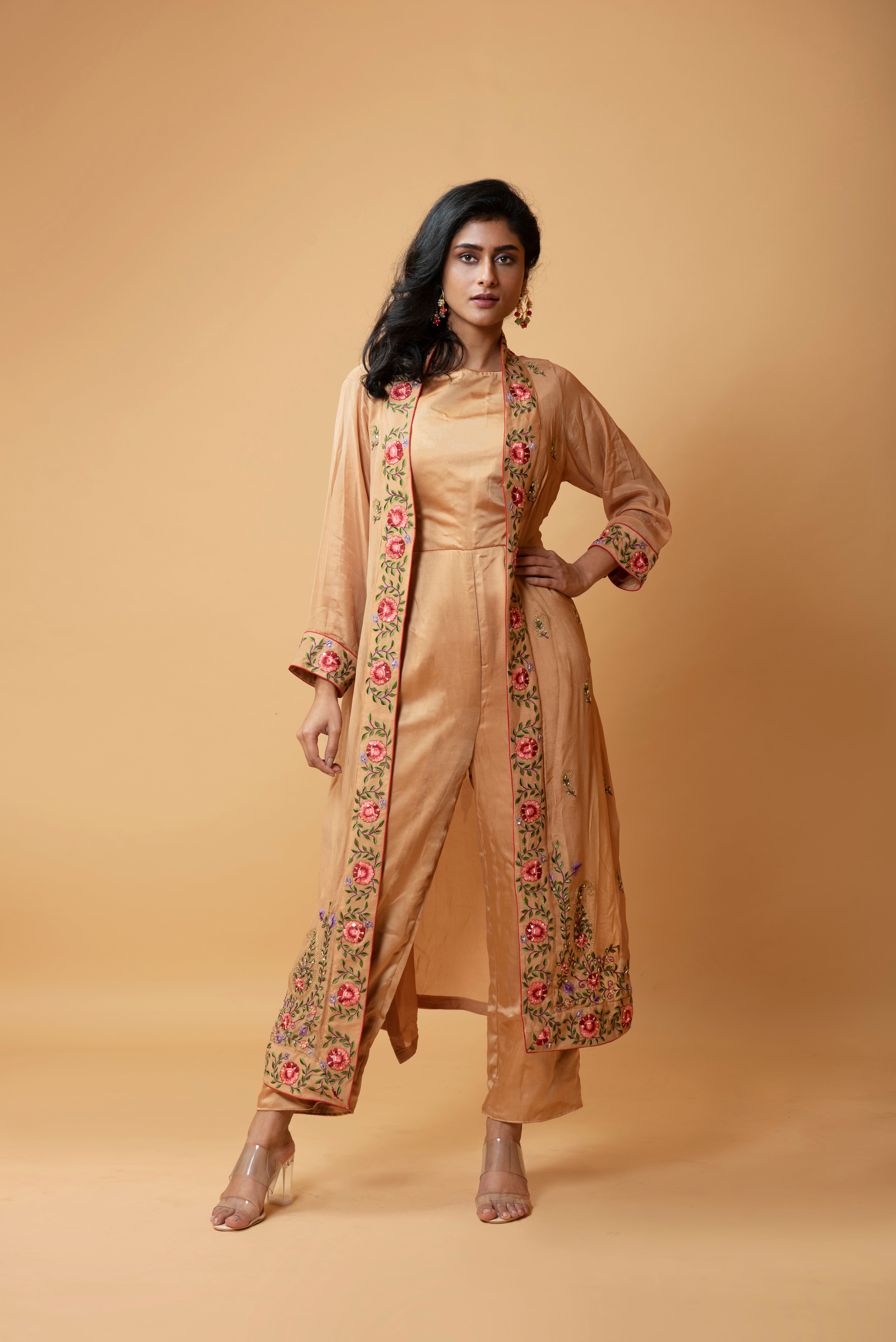 Light bronze jumpsuit with an embroidered jacket featuring floral motifs.