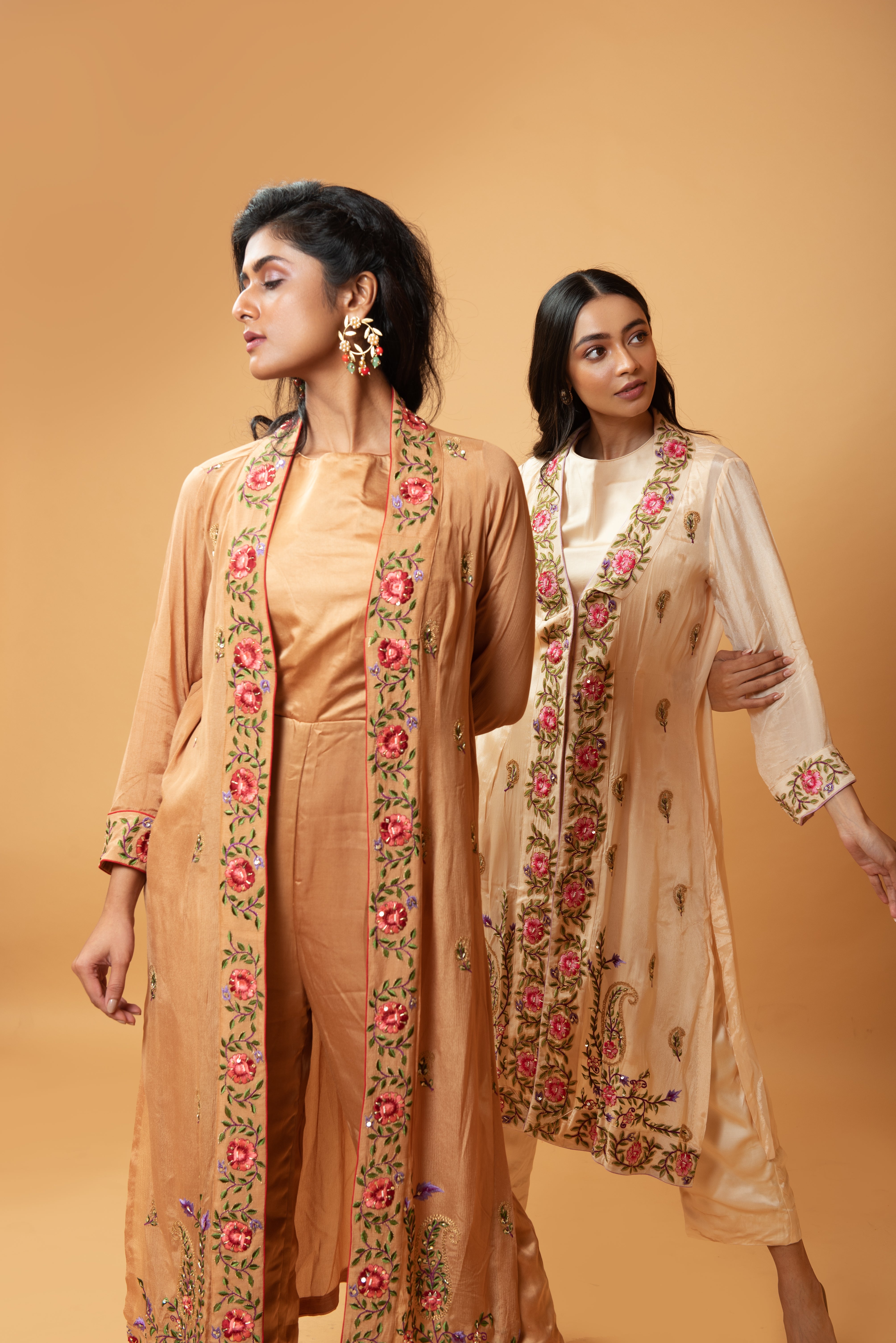 Champagne jumpsuit and jacket with floral embroidery and pockets.