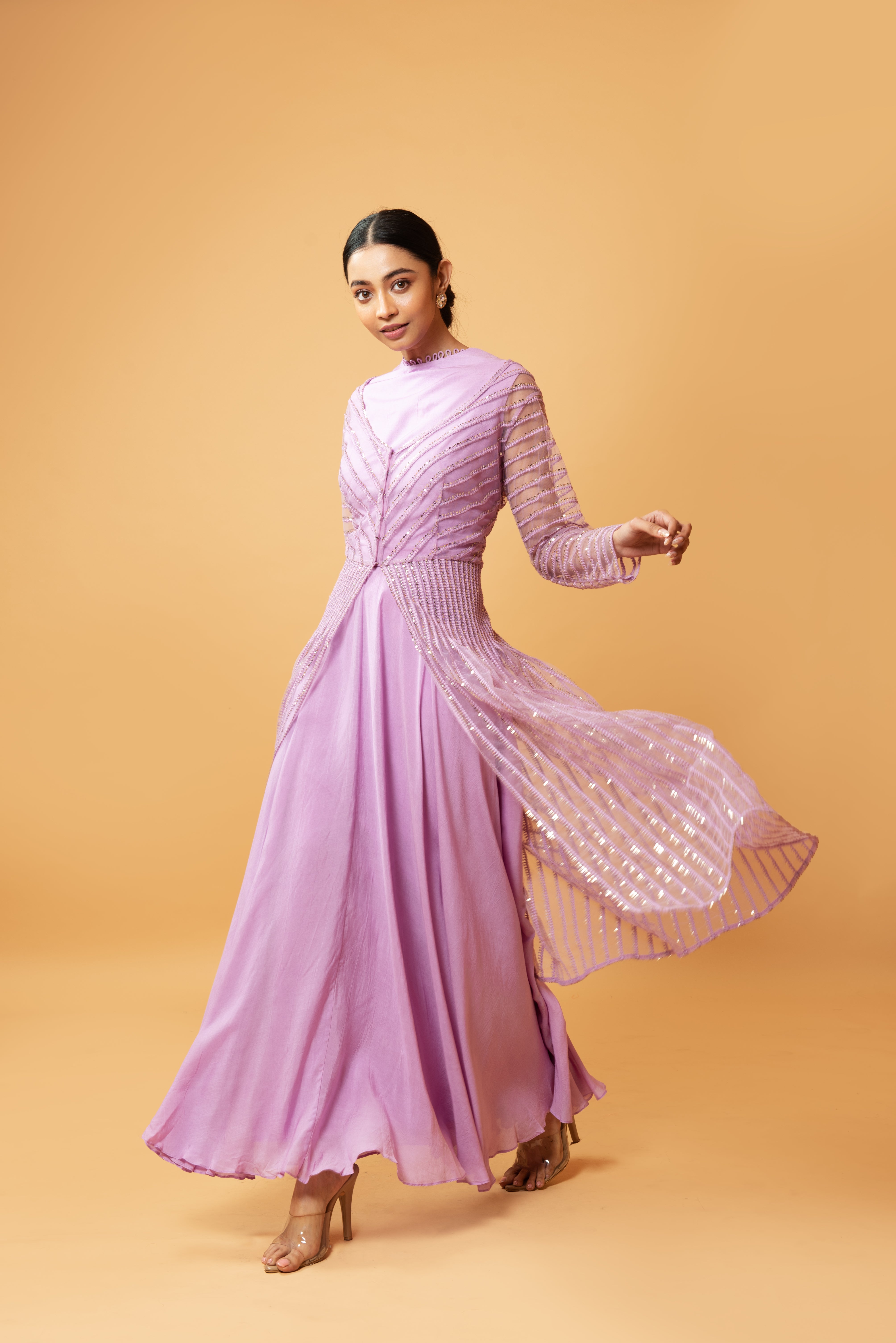 Lilac muslin gown with a sequined full-sleeved jacket.