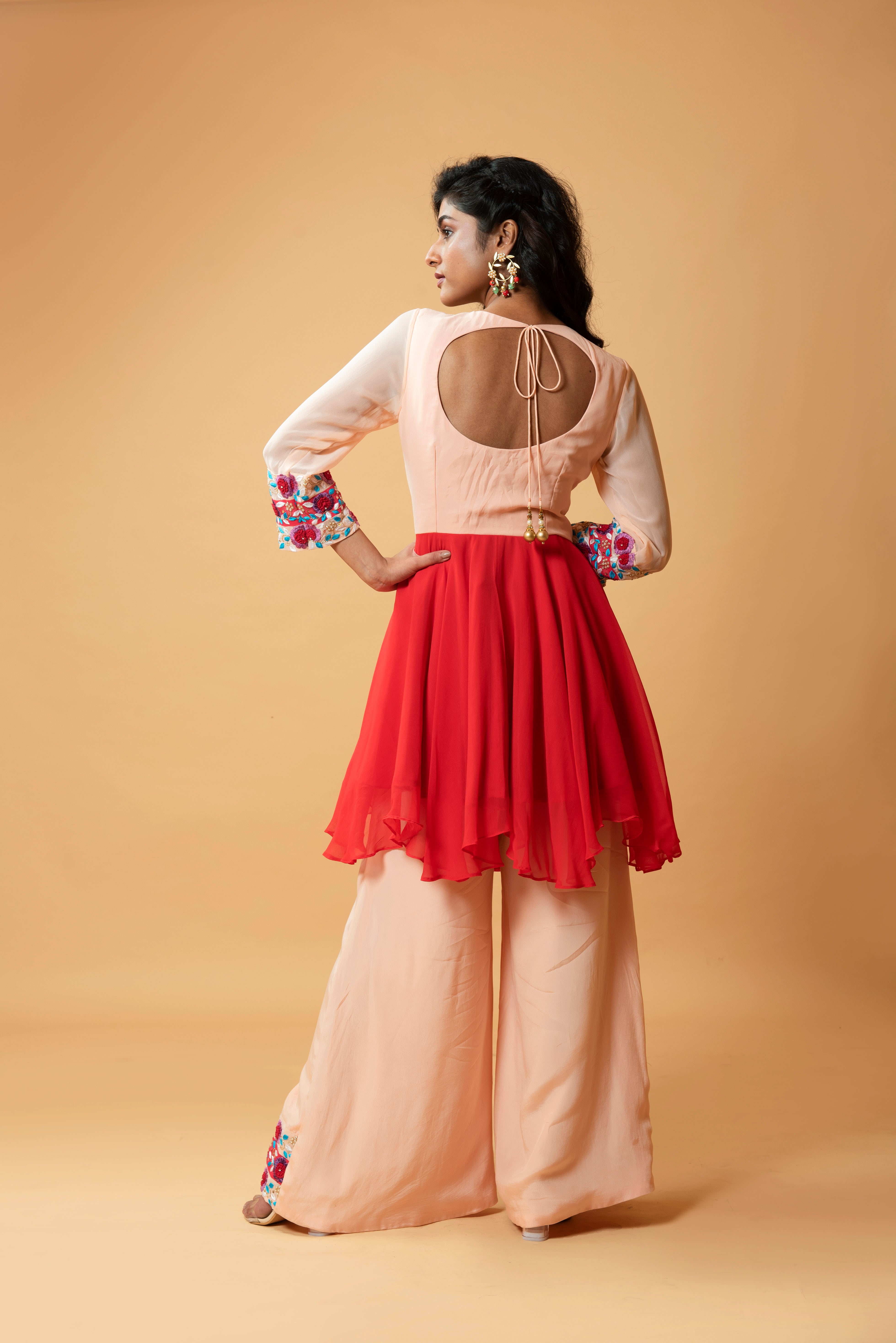 Red double-shaded sharara set with intricate floral hand embroidery.