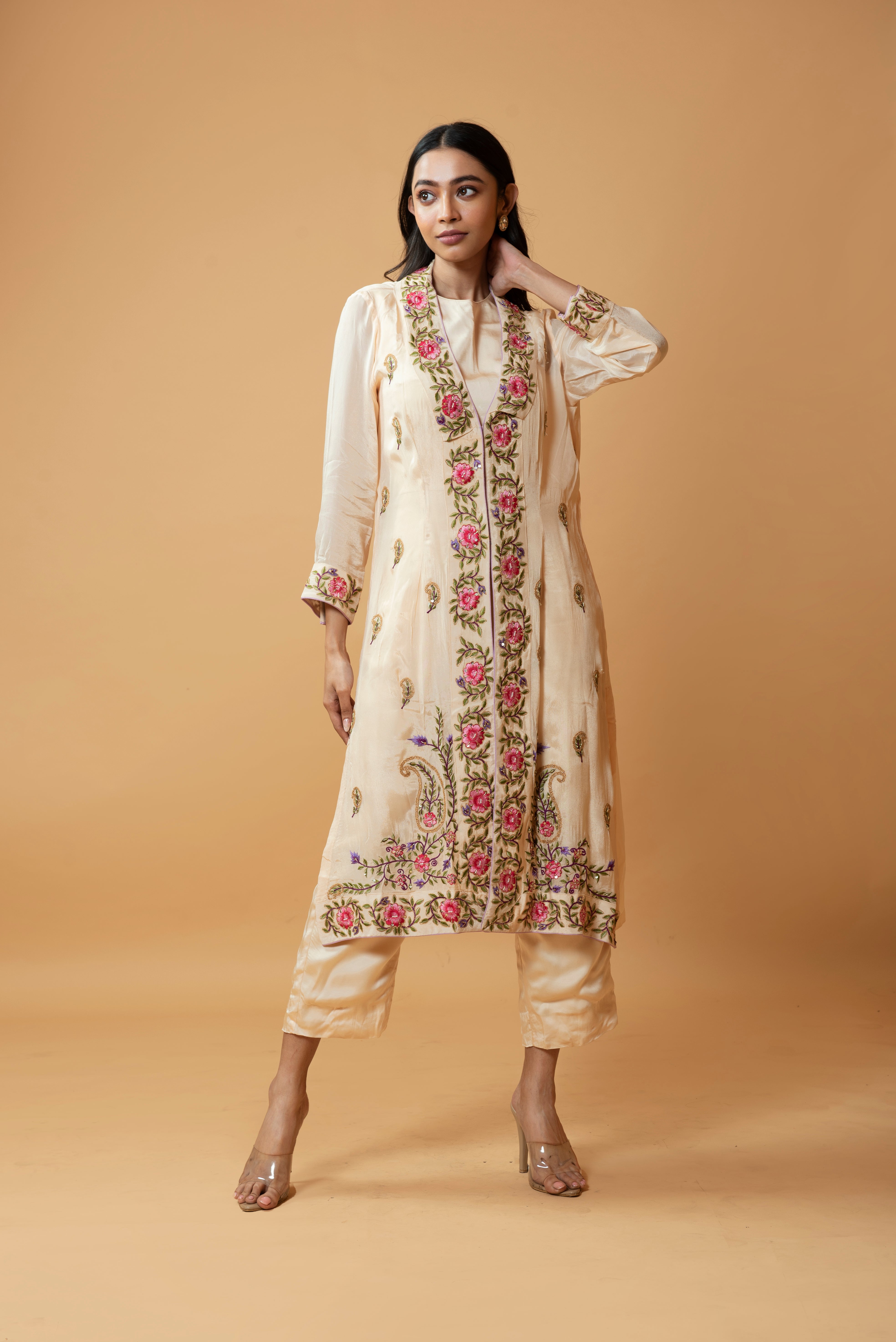 Champagne jumpsuit and jacket with floral embroidery and pockets.