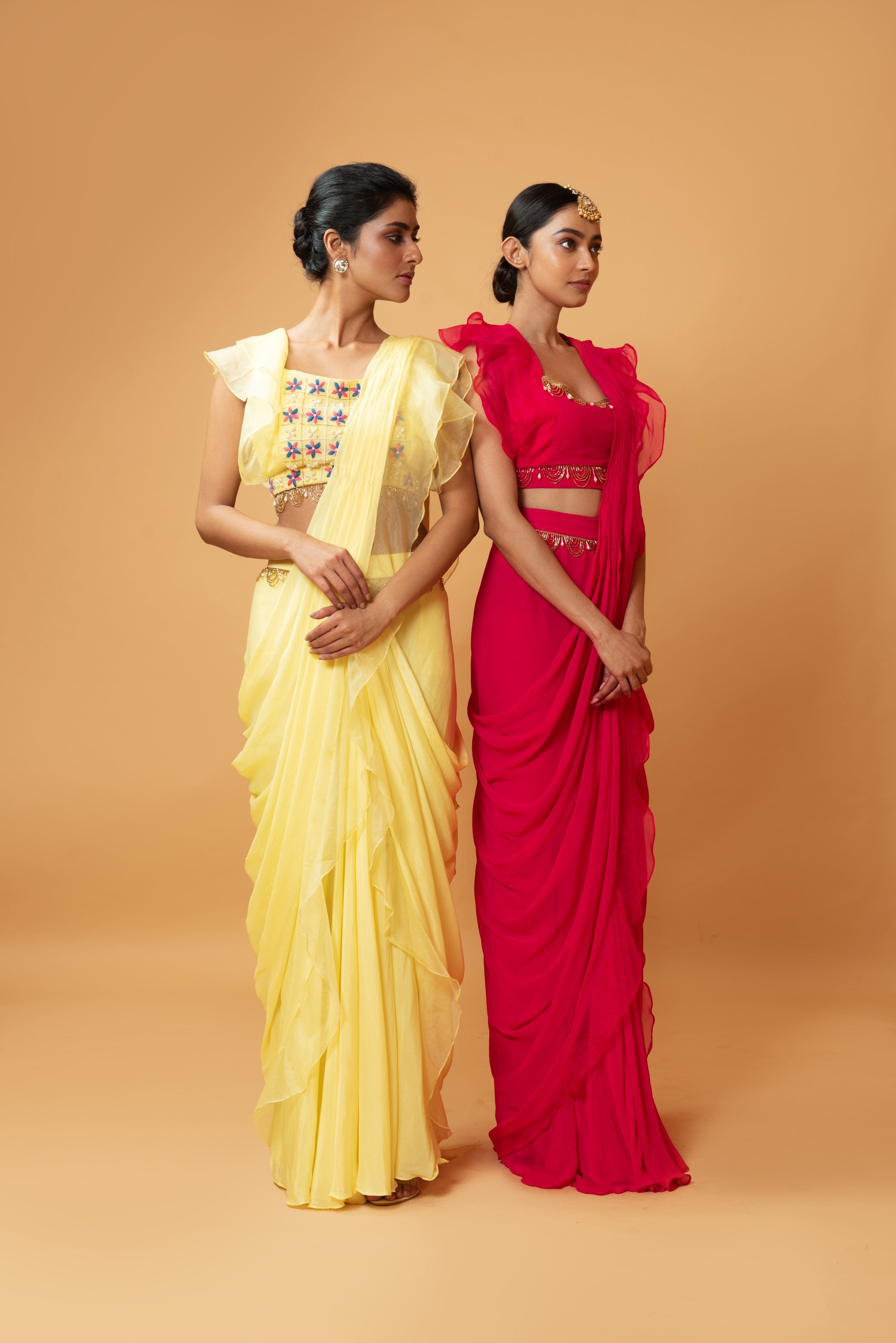Yellow ruffle saree with lace work and embroidered blouse featuring intricate handwork.