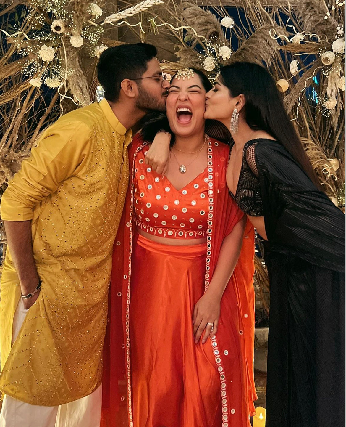 Sakshi Sindhwani wearing a tangerine orange dhoti set with mirror work blouse and cape.