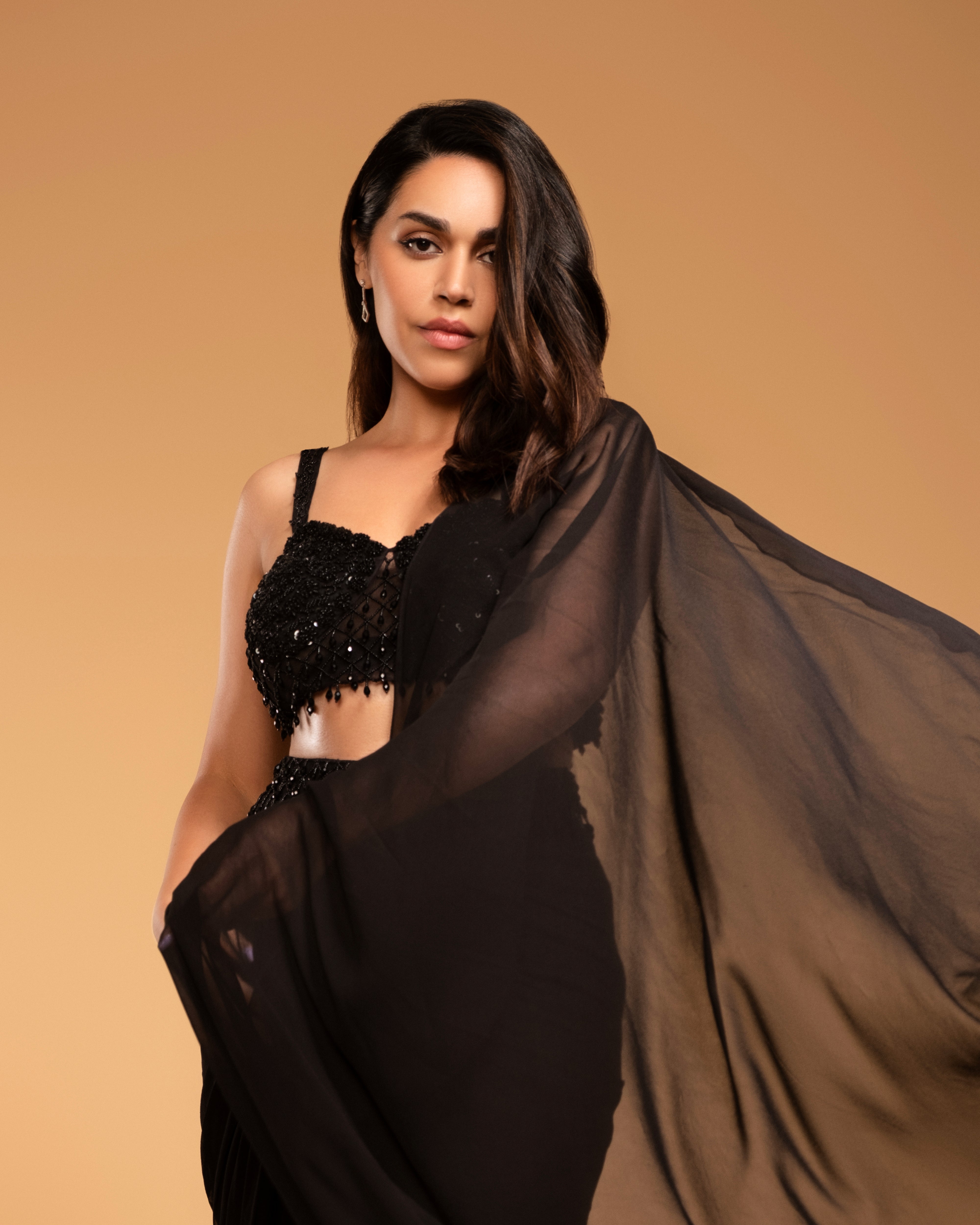 Naila Garewal in a black georgette saree with a hand-embroidered corset blouse.
