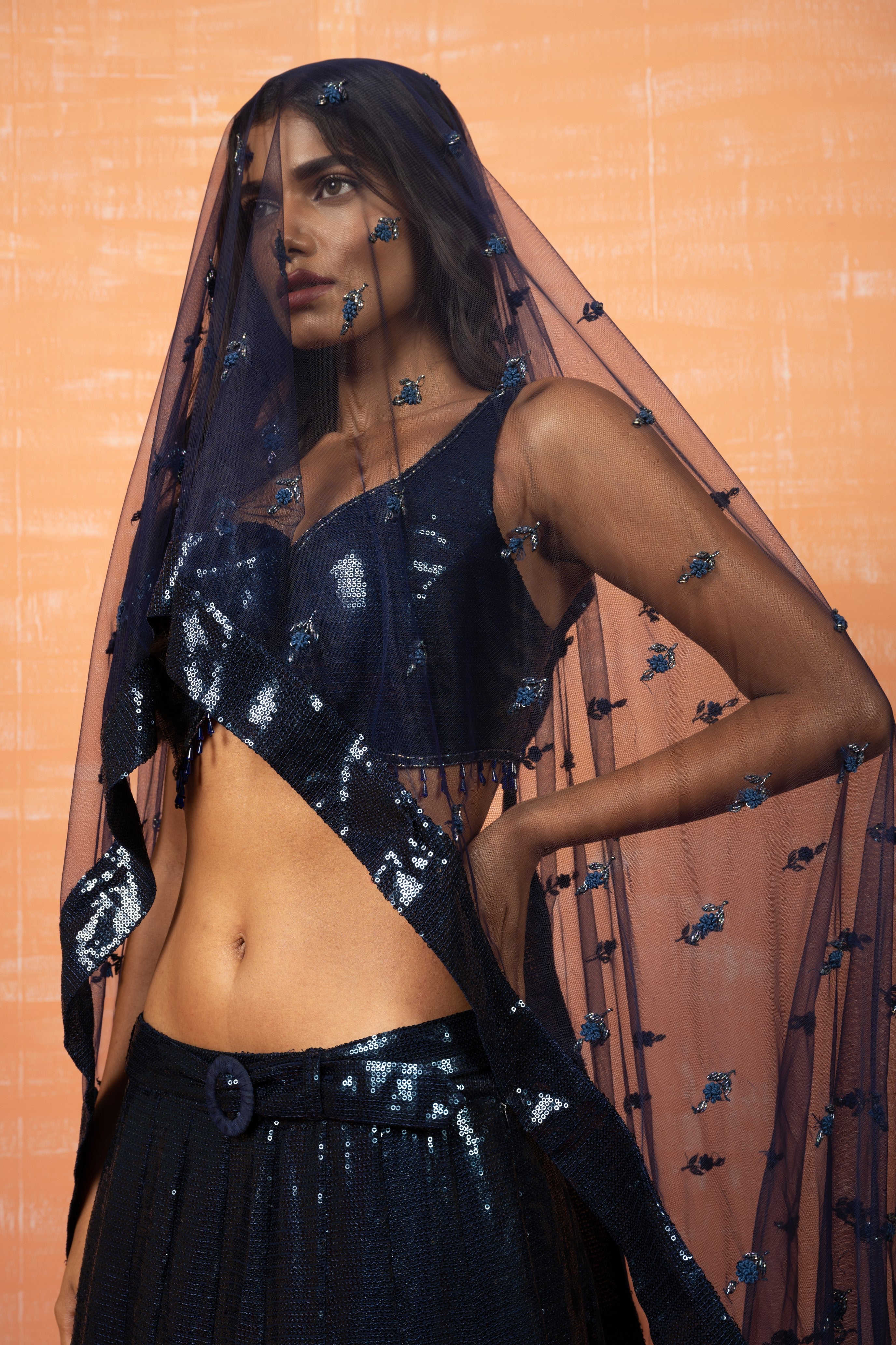 Deep blue sequin lehenga with a matching hand-embroidered dupatta and belt.