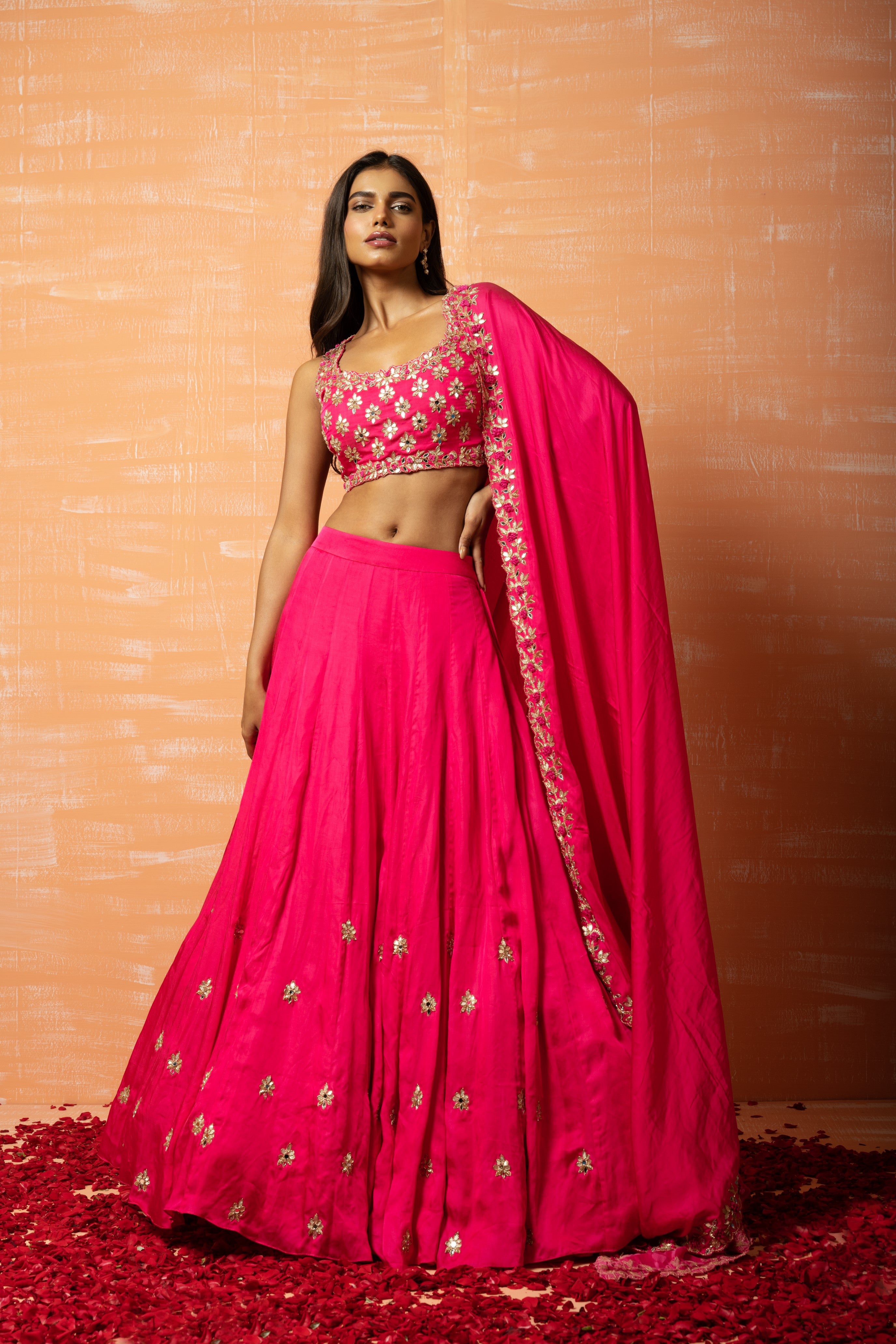Hot pink hand-embroidered lehenga in modal silk for a stunning traditional look.
