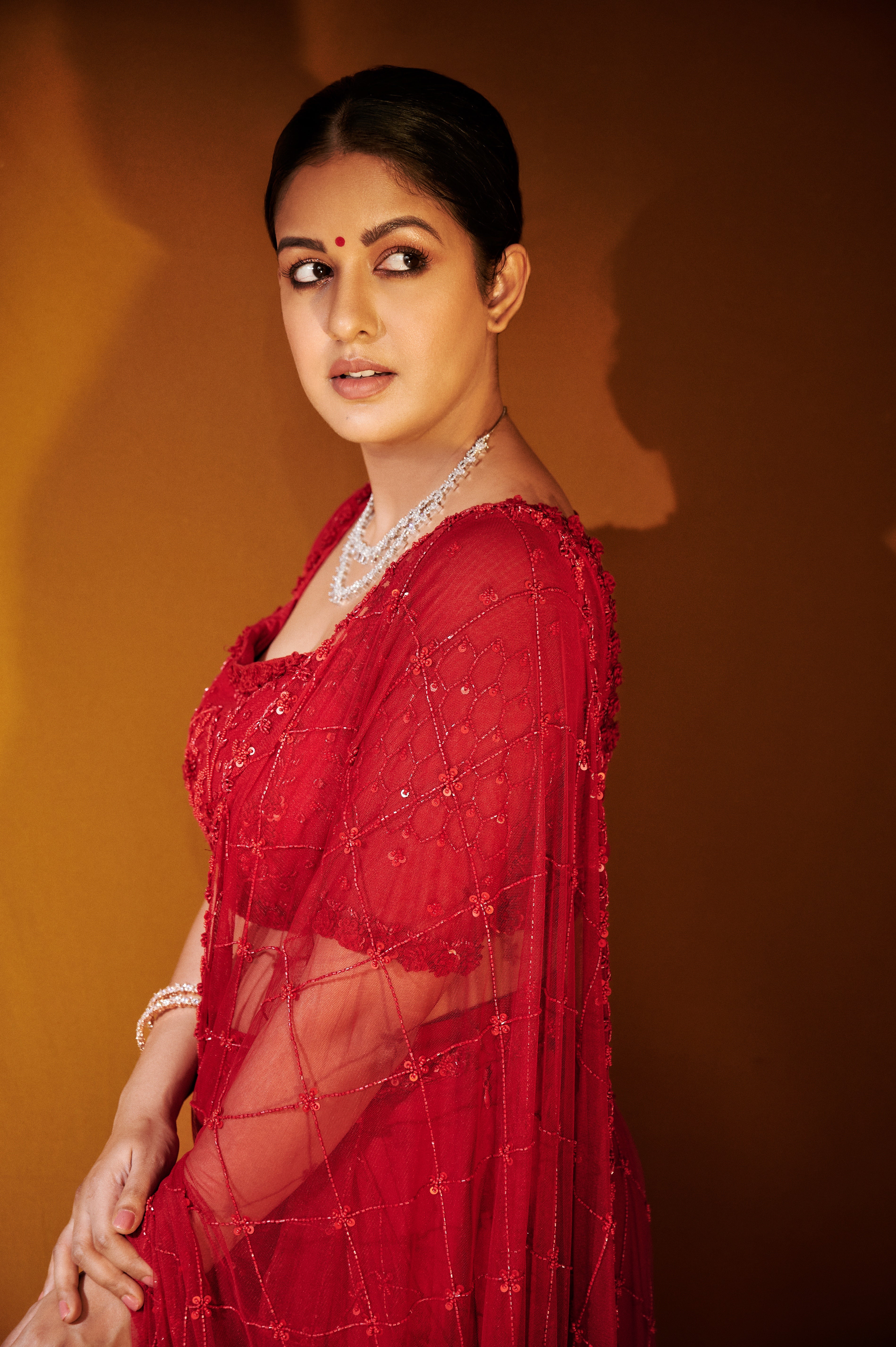 Ishita Dutta Sheth wearing a red soft net and georgette saree with intricate hand embroidery.
