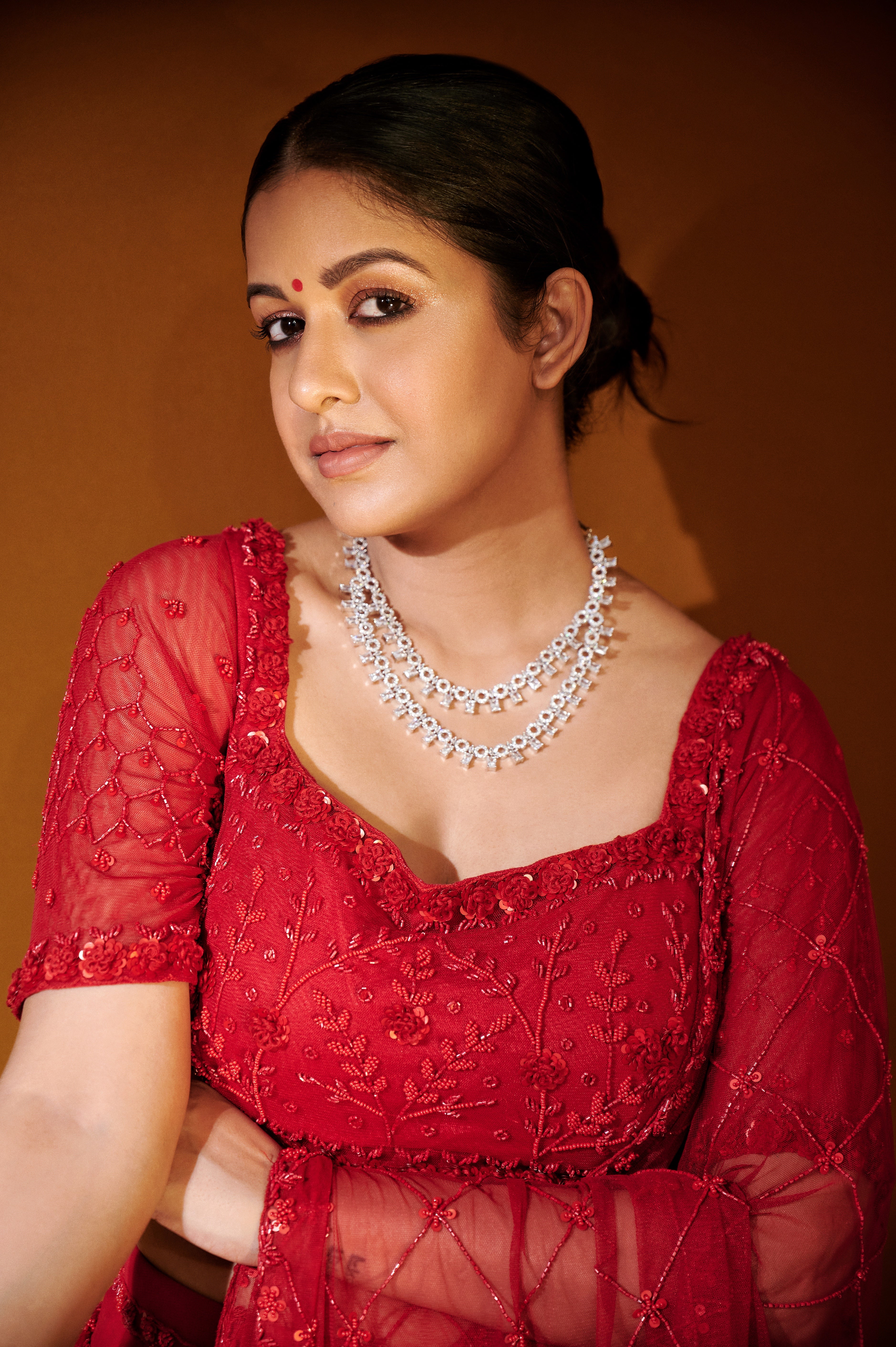 Ishita Dutta Sheth wearing a red soft net and georgette saree with intricate hand embroidery.