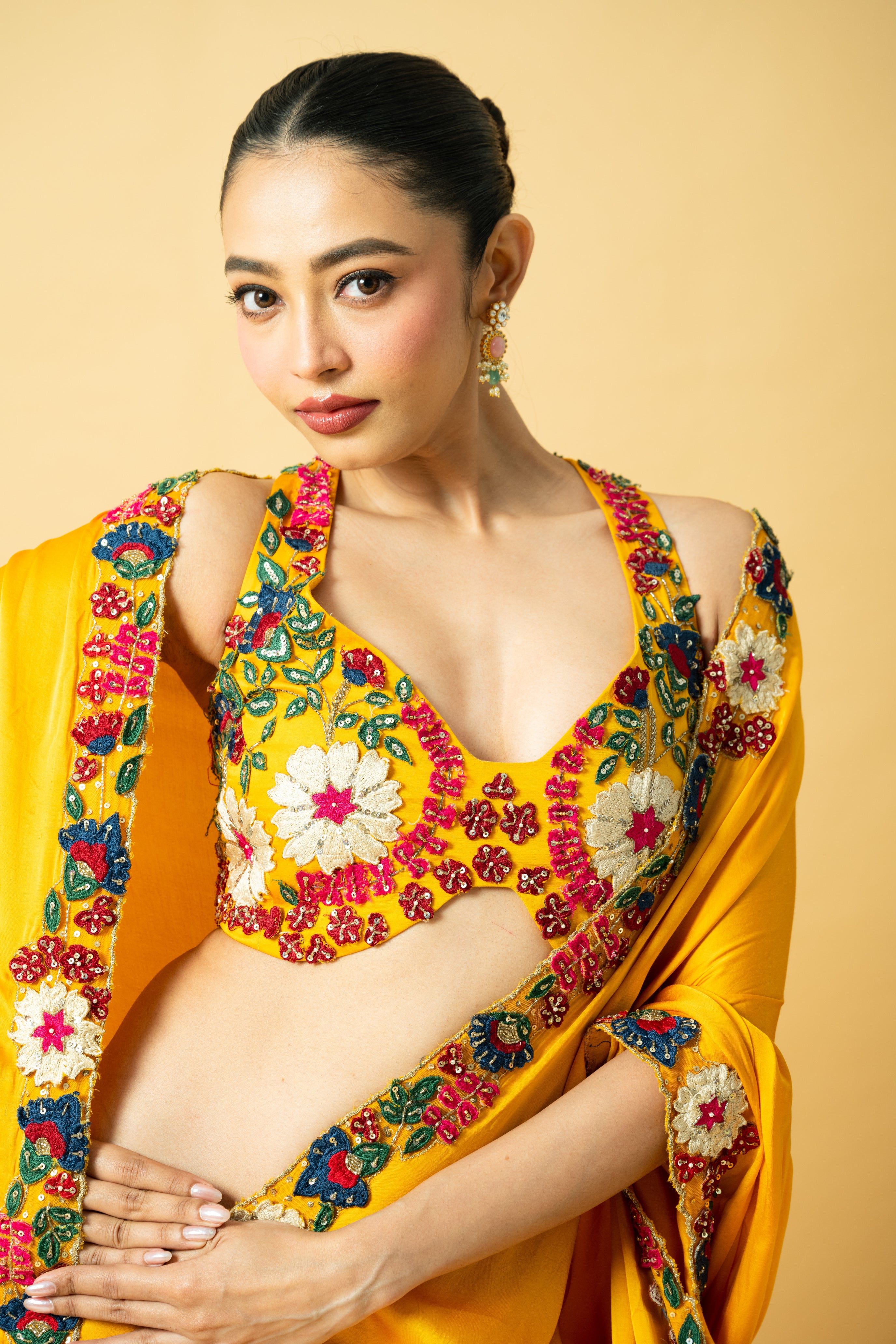 Golden yellow saree with multi-colored 3D hand embroidery.