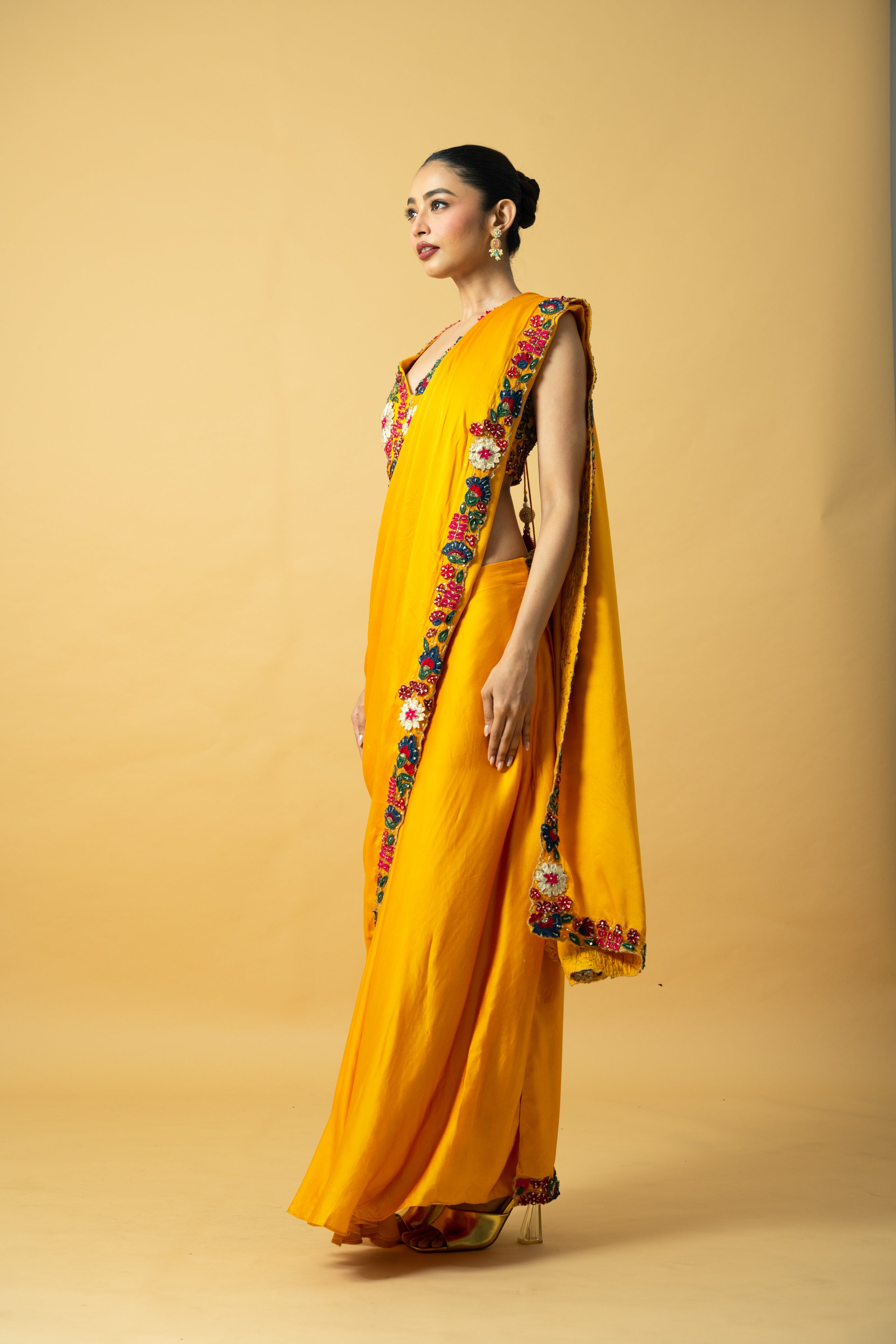 Golden yellow saree with multi-colored 3D hand embroidery.