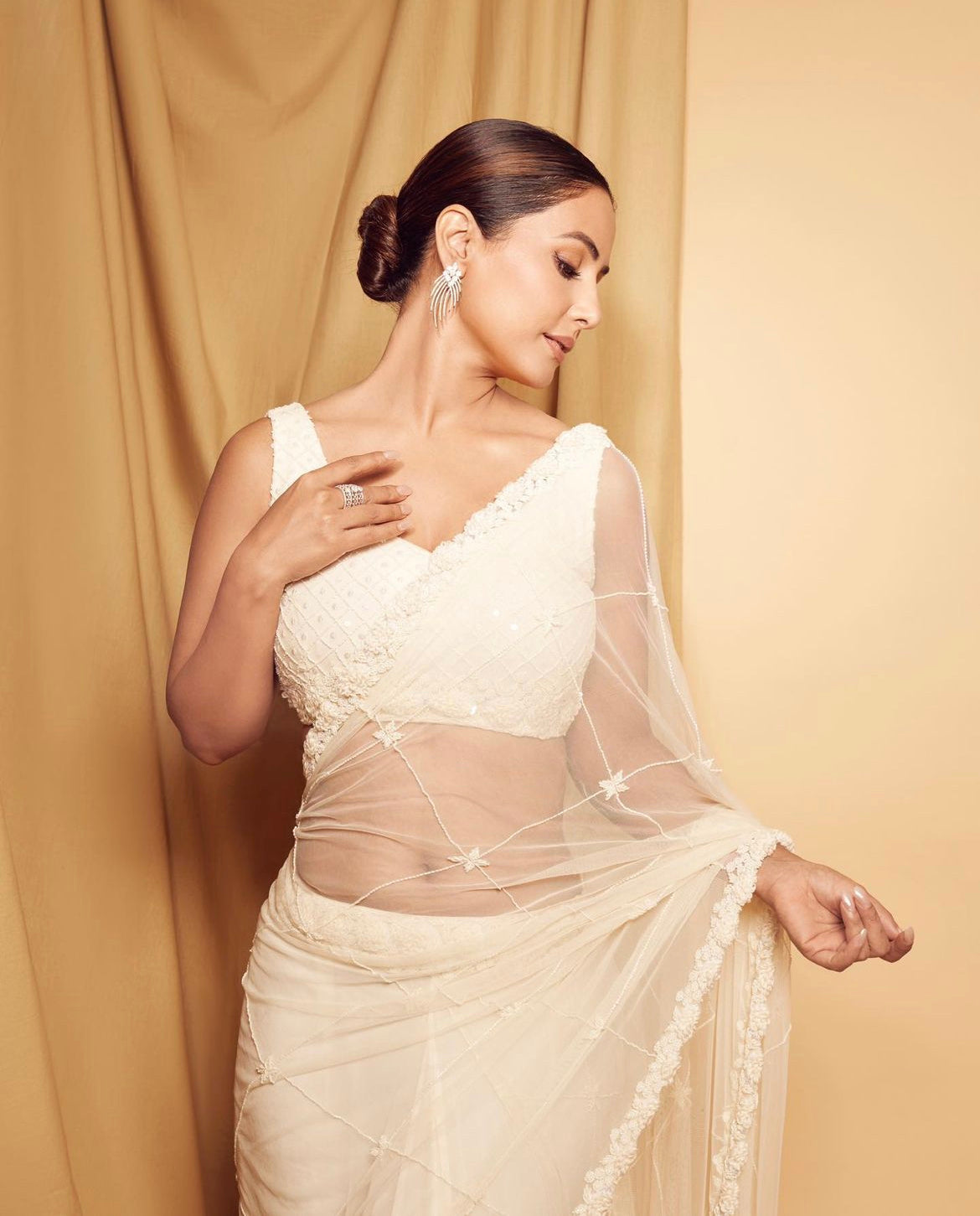Hina Khan wearing an ivory pre-stitched saree with hand embroidery.