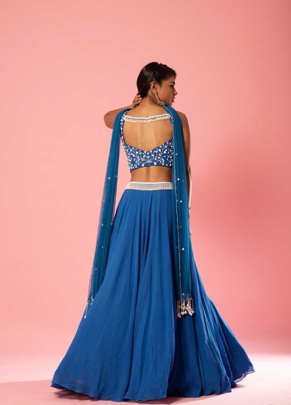 Cobalt blue lehenga with pearl embroidery and choker-style dupatta.
