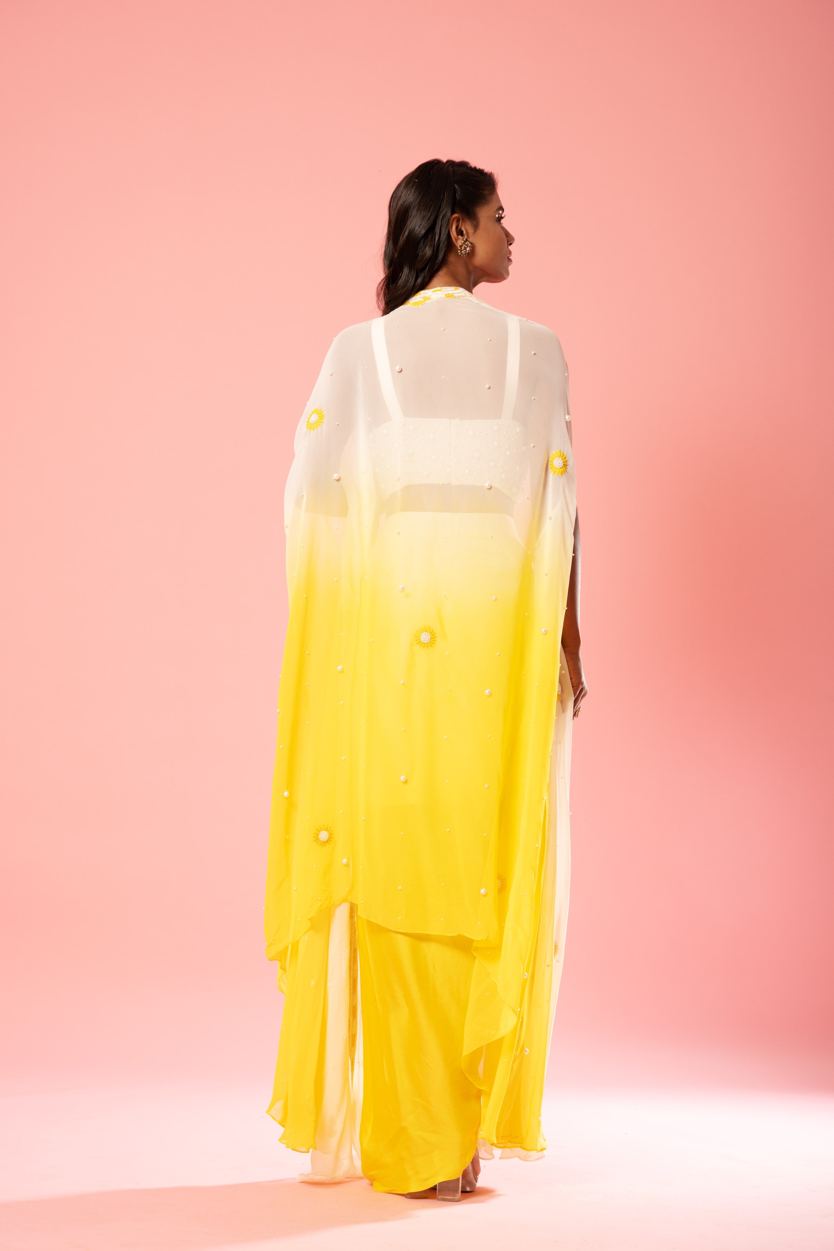 Ivory and yellow ombre dhoti set with pearl-adorned blouse and hand-embroidered jacket.