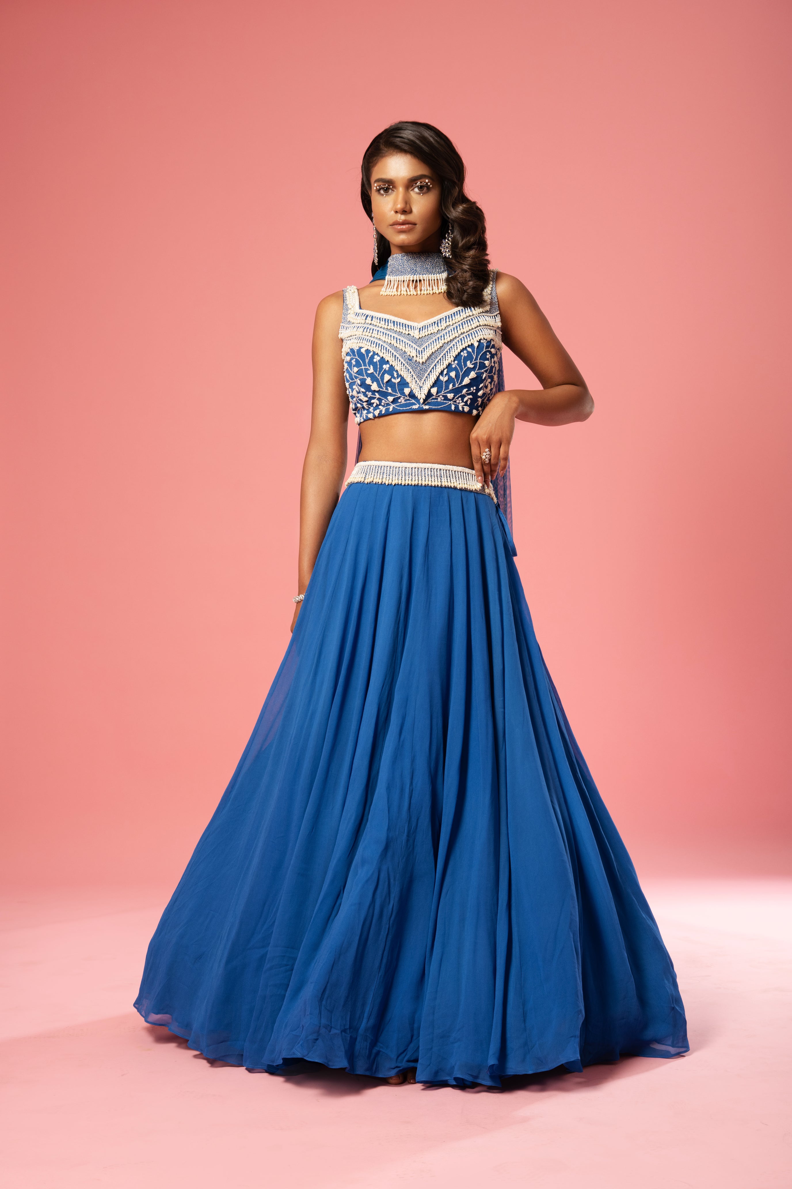 Cobalt blue lehenga with pearl embroidery and choker-style dupatta.