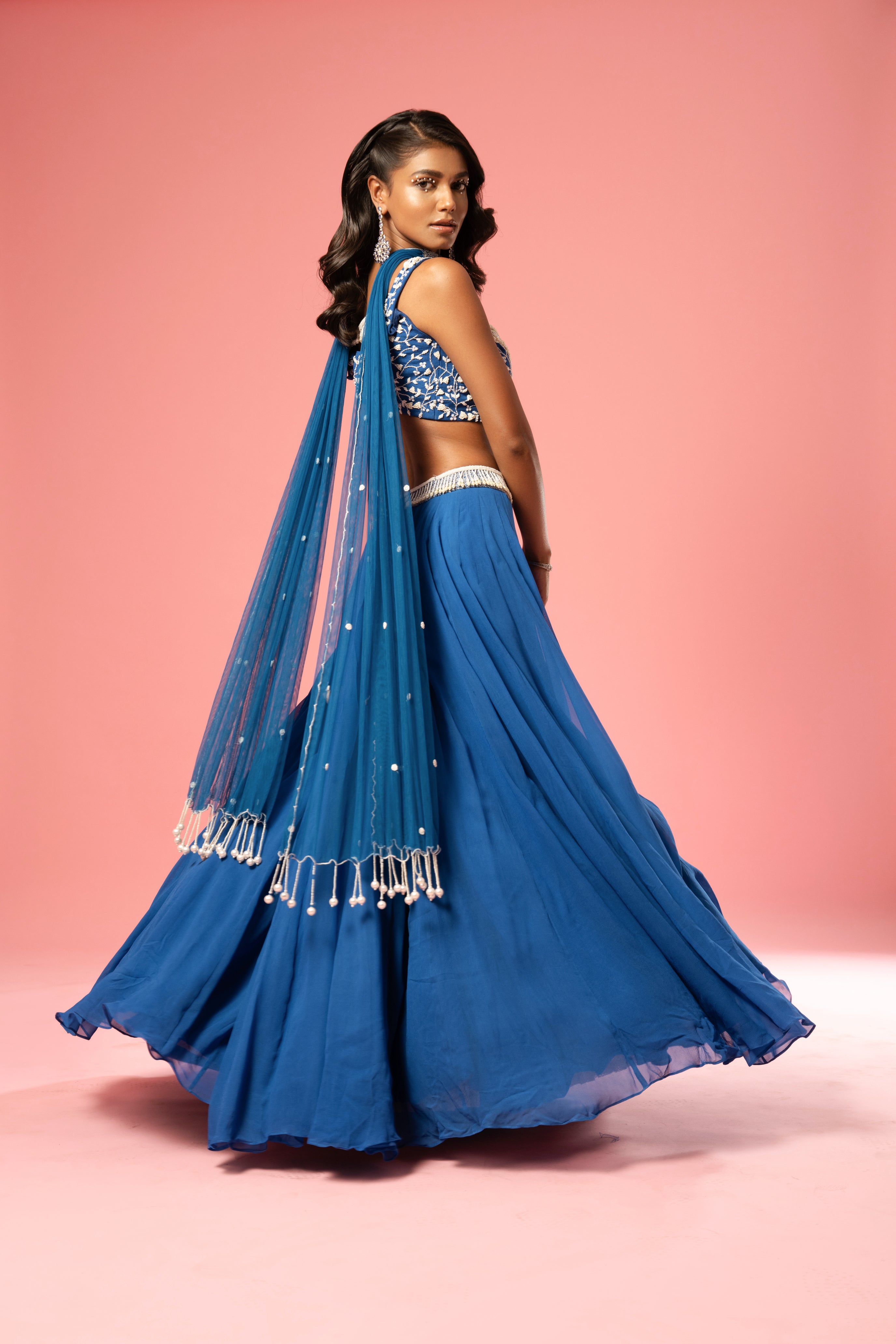 Cobalt blue lehenga with pearl embroidery and choker-style dupatta.