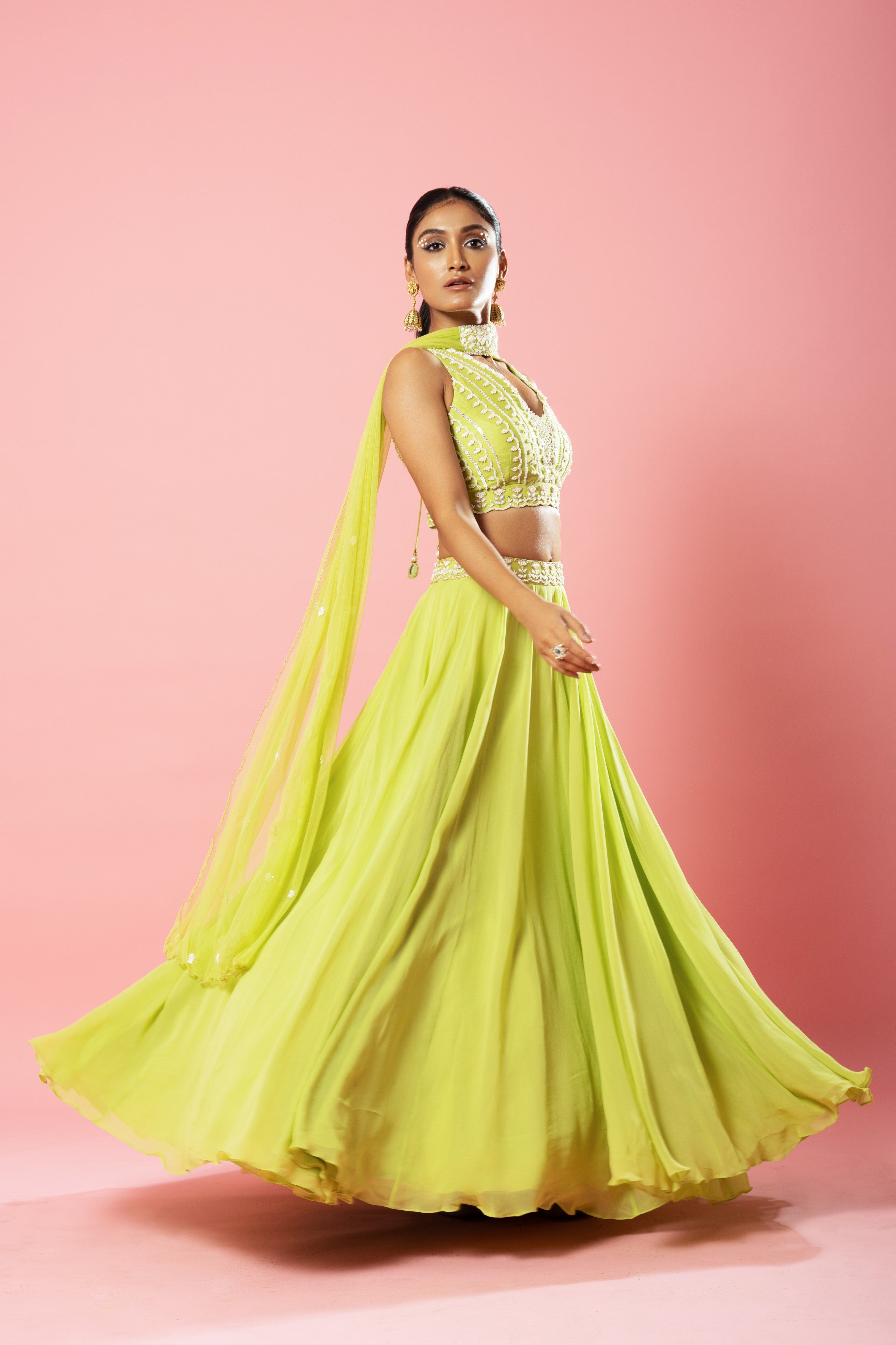 Lime green georgette lehenga with hand embroidery and a choker-style dupatta.