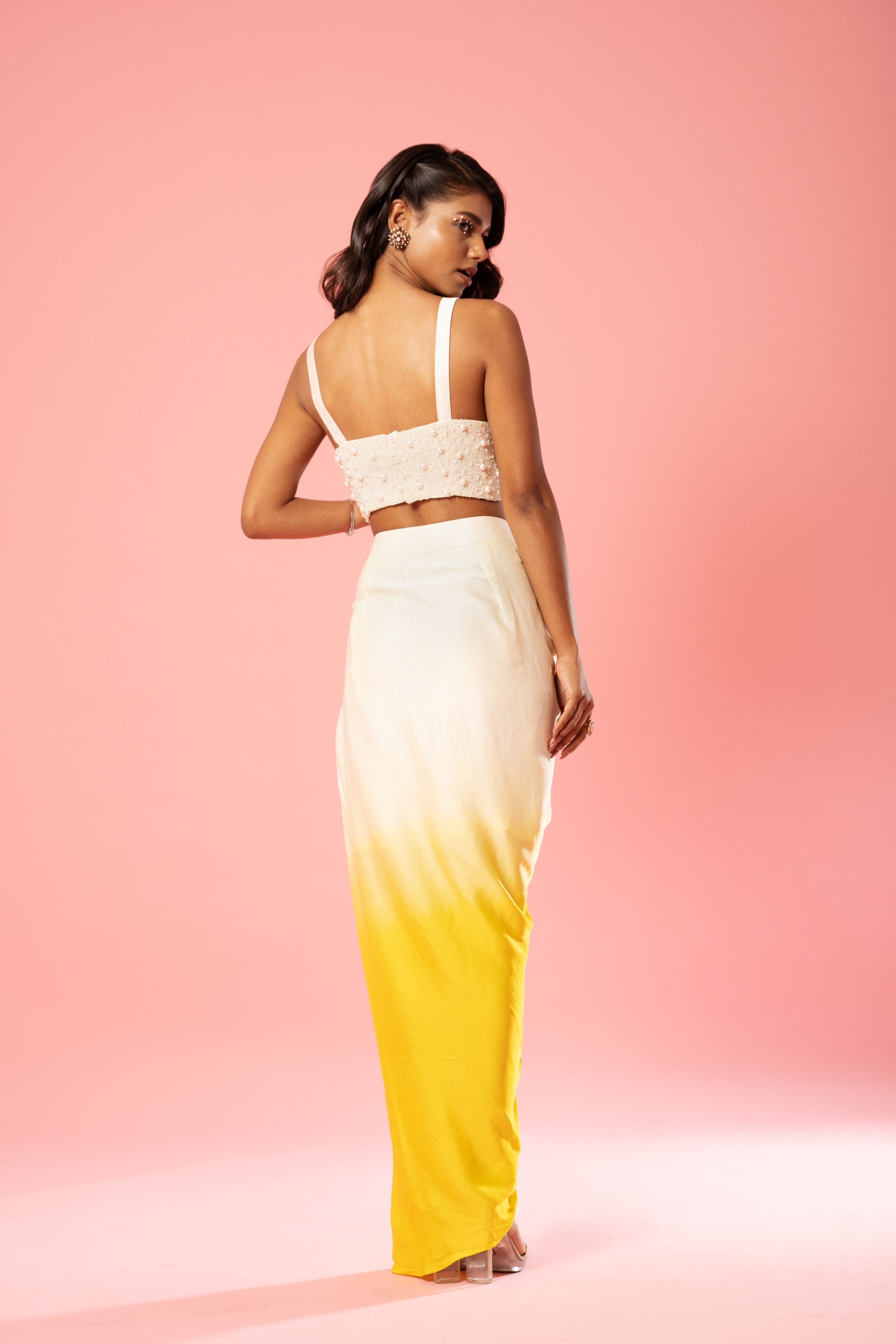 Ivory and yellow ombre dhoti set with pearl-adorned blouse and hand-embroidered jacket.