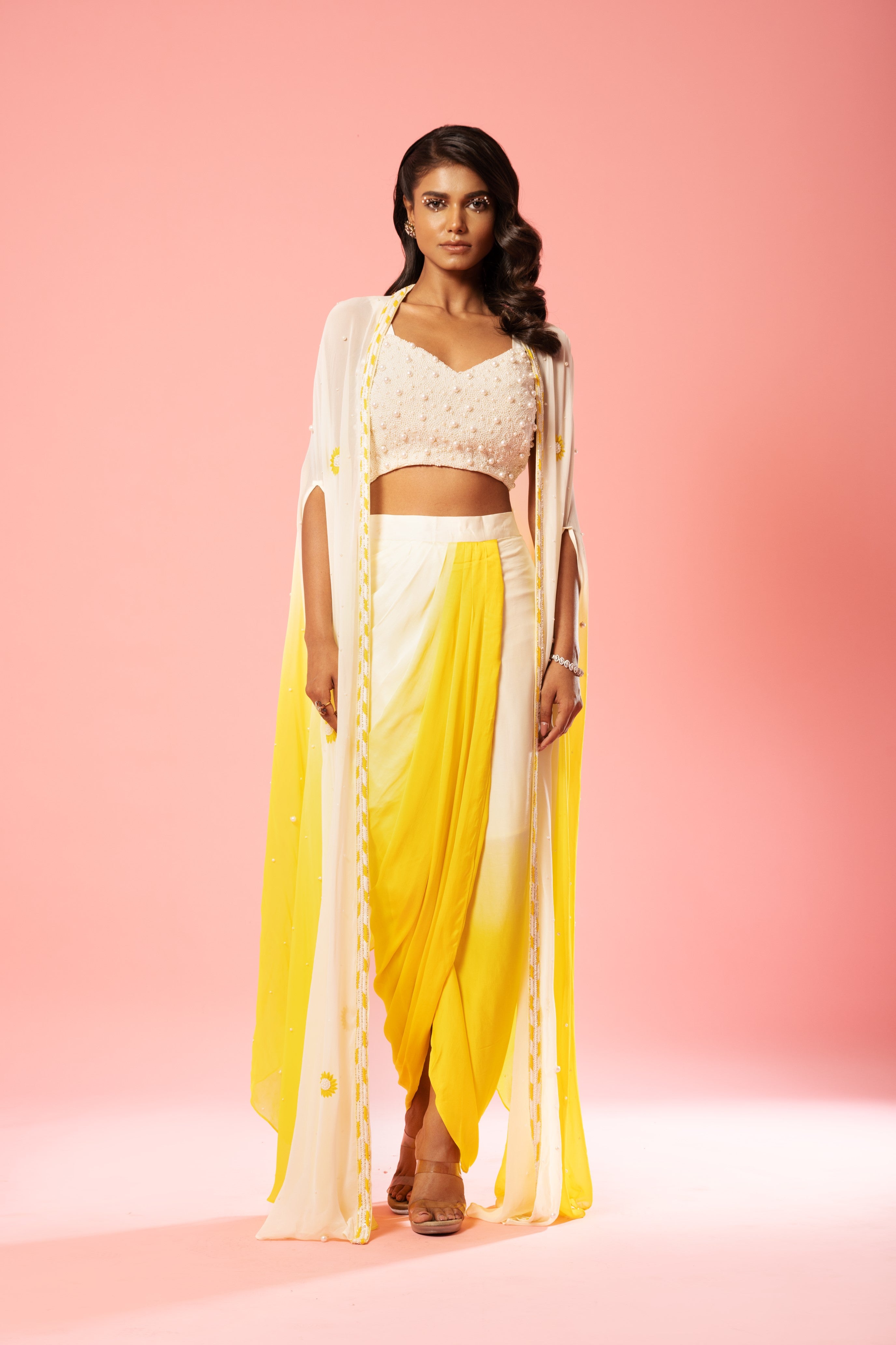 Ivory and yellow ombre dhoti set with pearl-adorned blouse and hand-embroidered jacket.