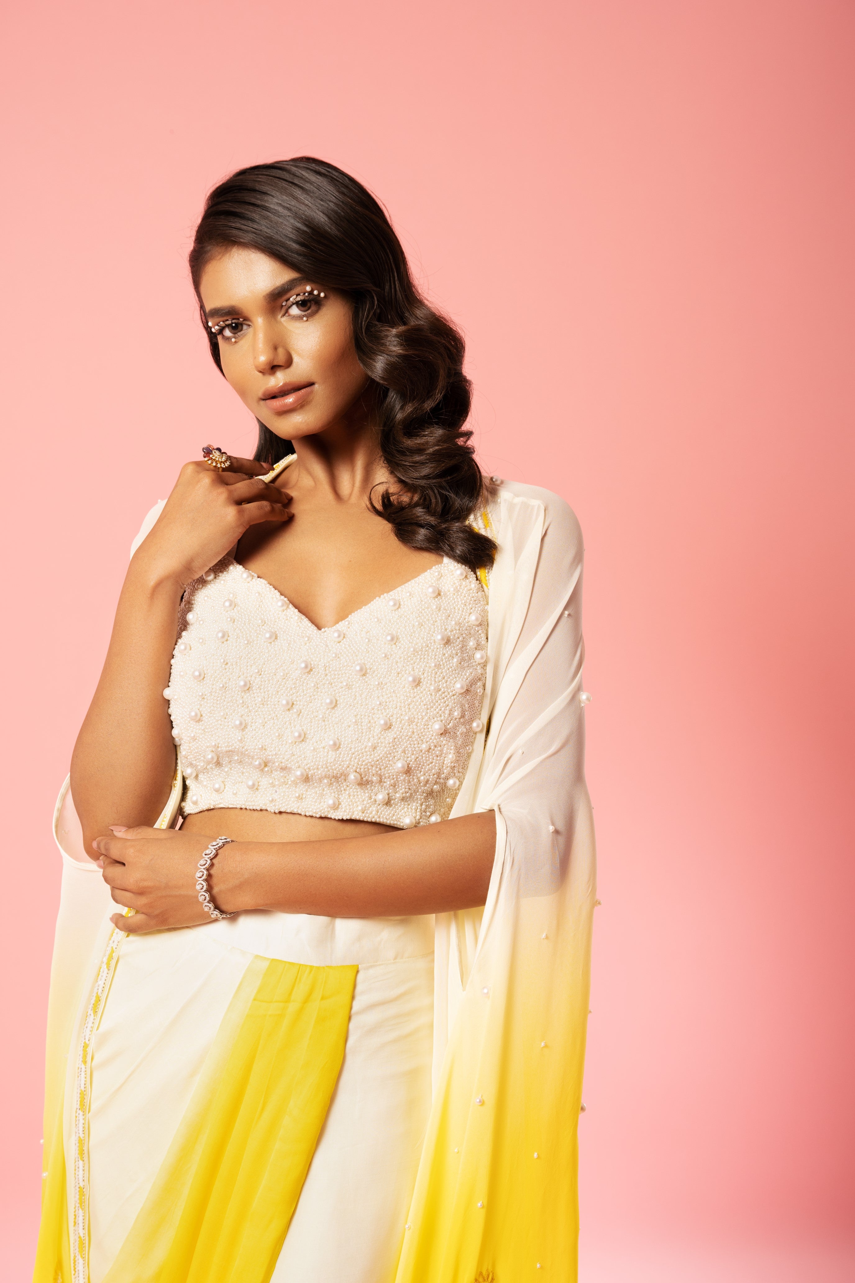 Ivory and yellow ombre dhoti set with pearl-adorned blouse and hand-embroidered jacket.