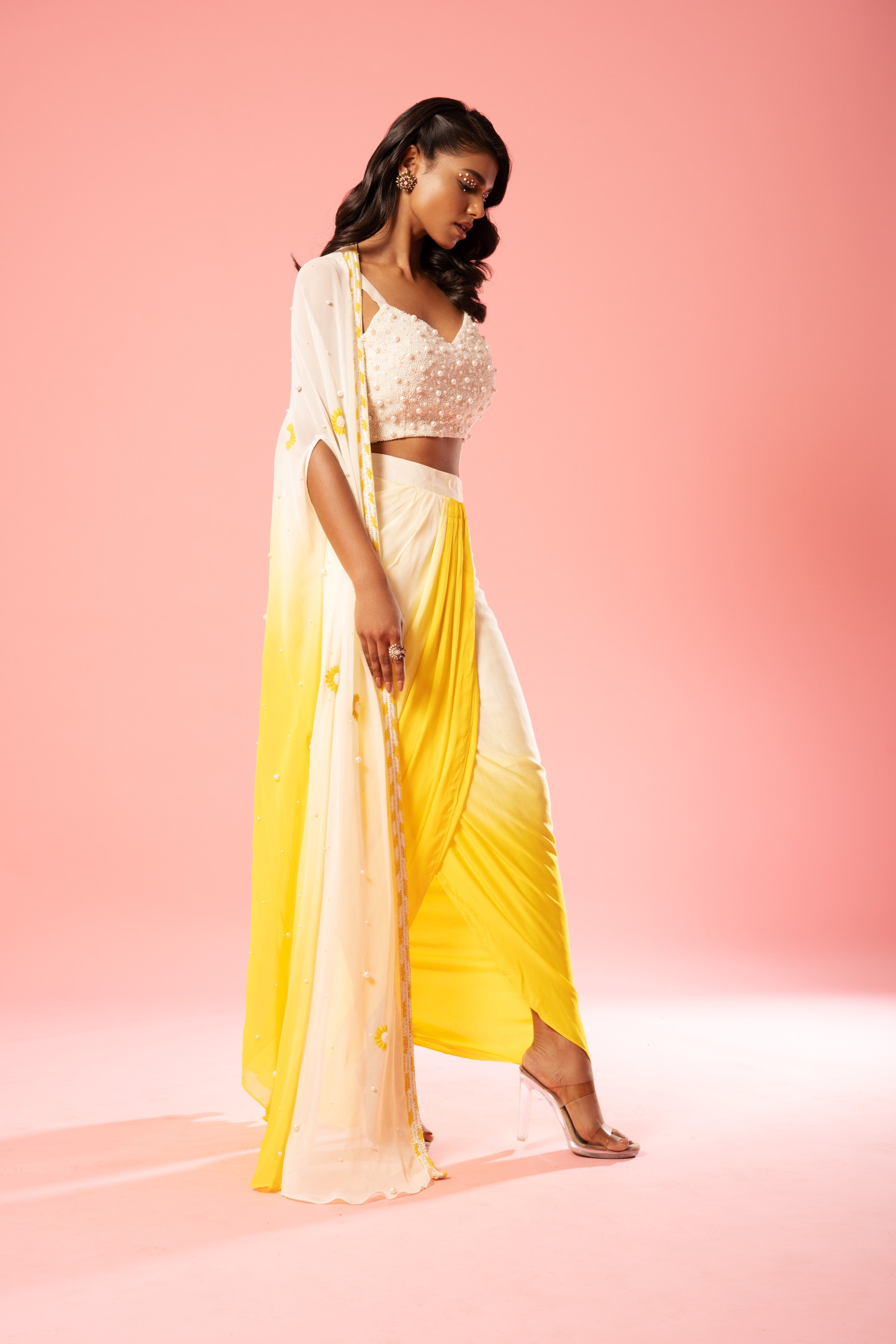Ivory and yellow ombre dhoti set with pearl-adorned blouse and hand-embroidered jacket.