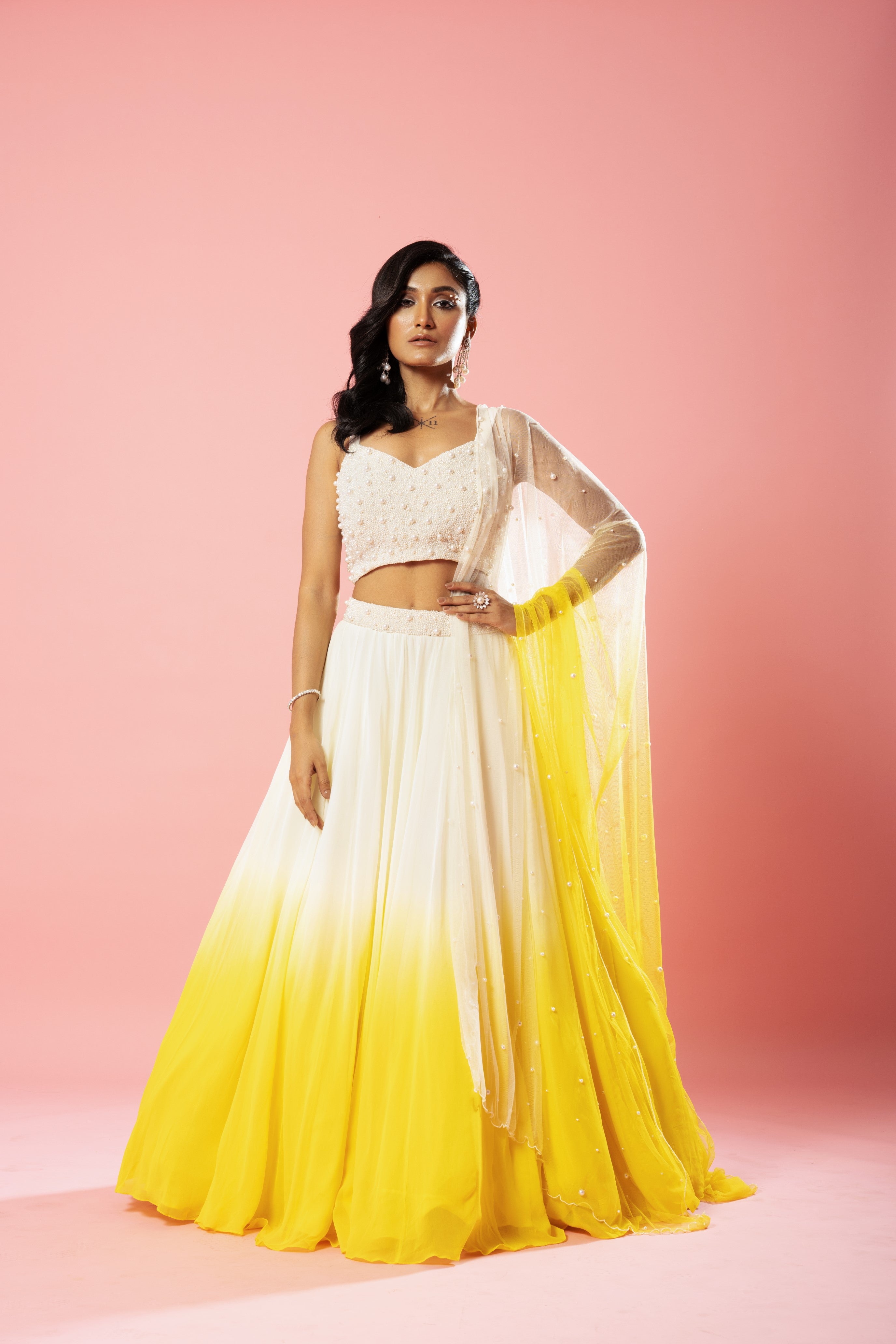Ivory and yellow ombre lehenga with pearl-embellished dupatta.