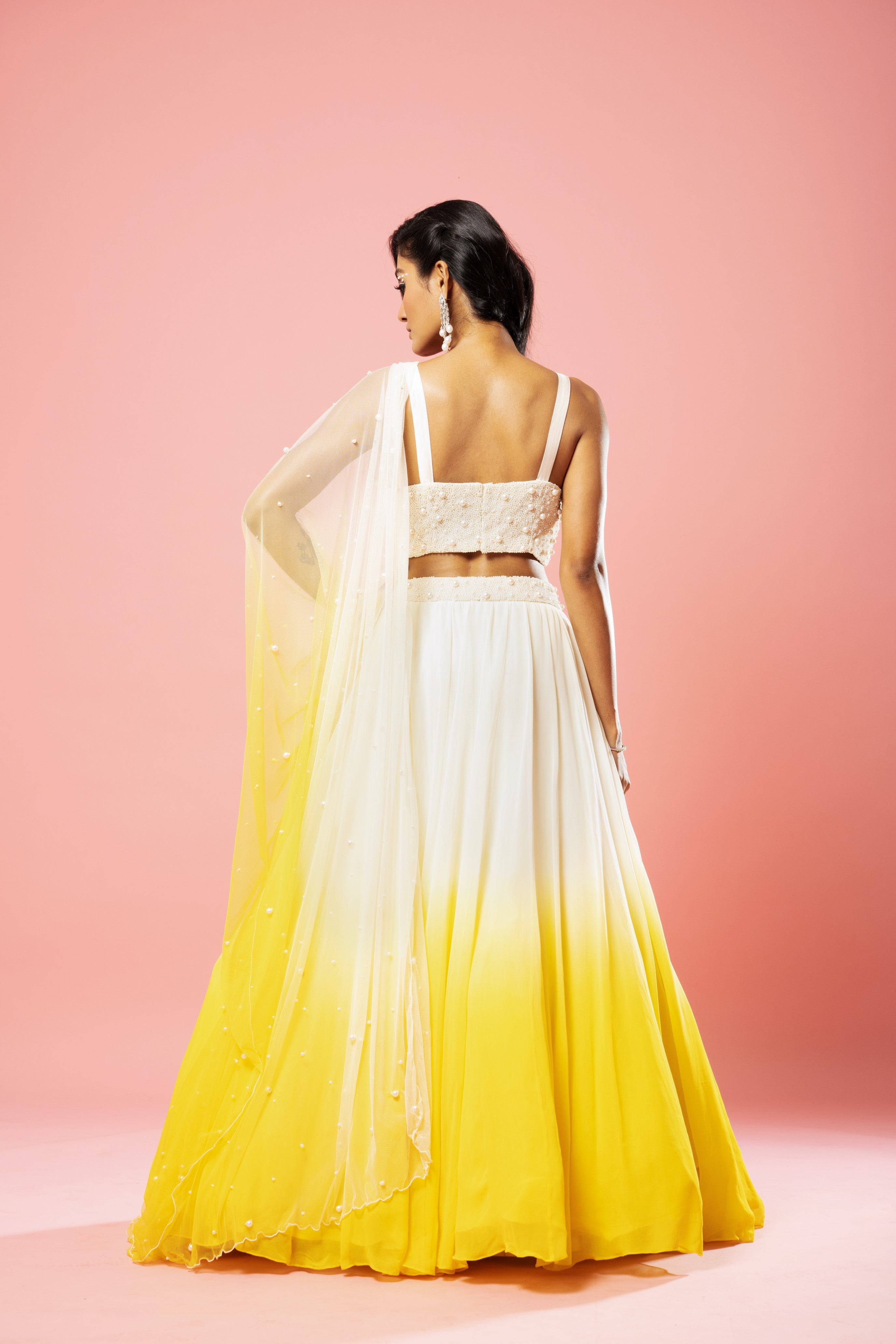Ivory and yellow ombre lehenga with pearl-embellished dupatta.