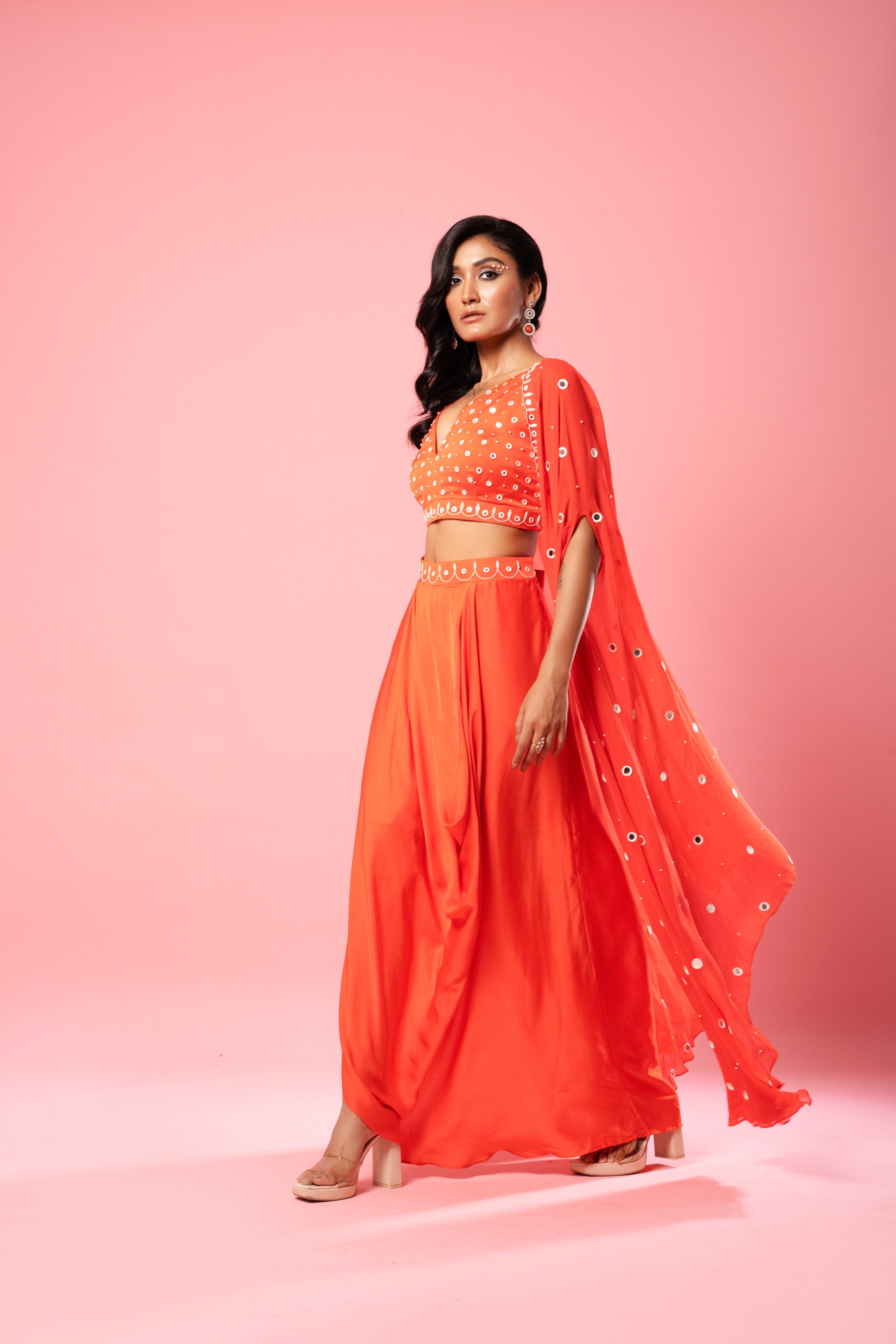 Tangerine orange dhoti set with mirror work blouse and georgette cape.