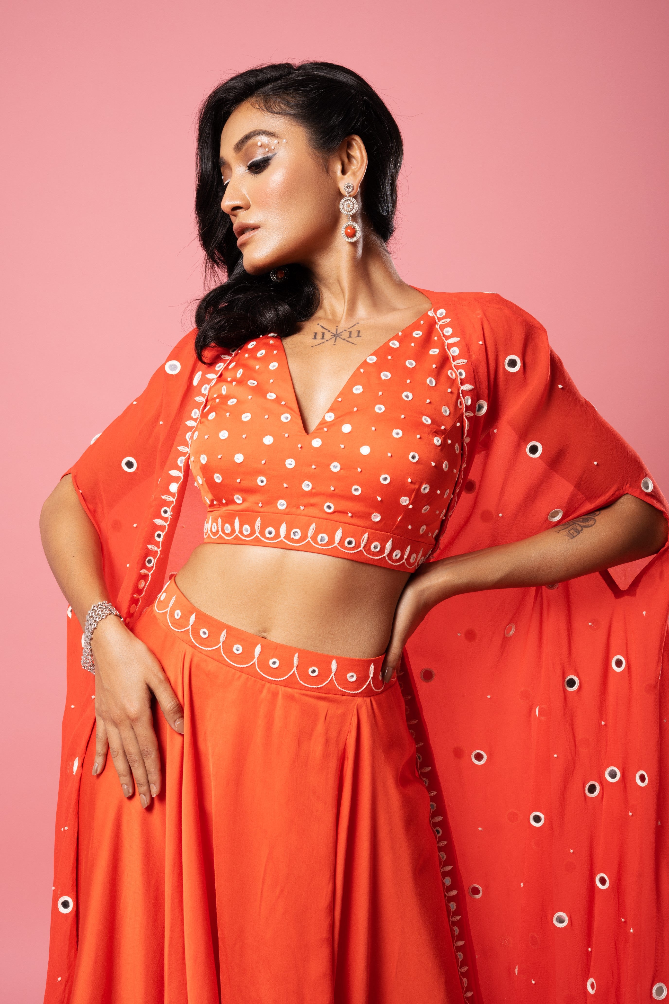 Tangerine orange dhoti set with mirror work blouse and georgette cape.
