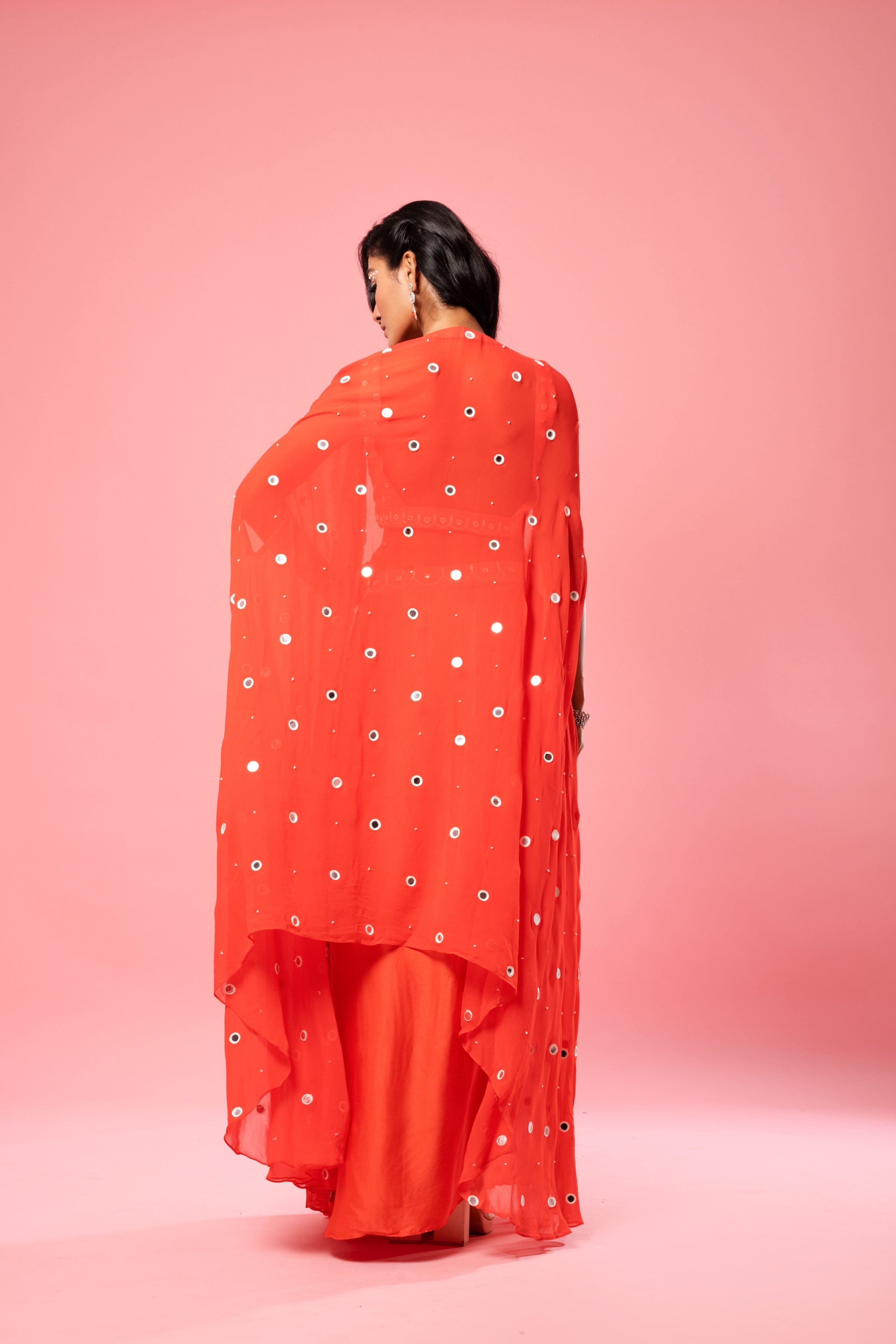 Tangerine orange dhoti set with mirror work blouse and georgette cape.